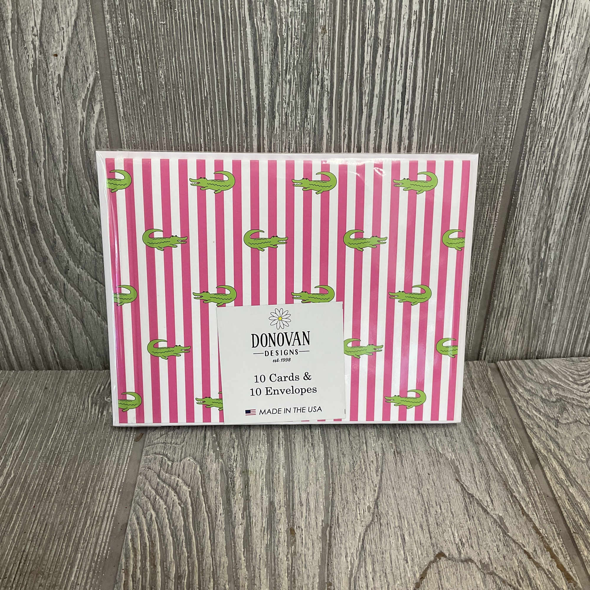 Bright pink-and-white vertical stripes meet cute green alligators in a boxed set