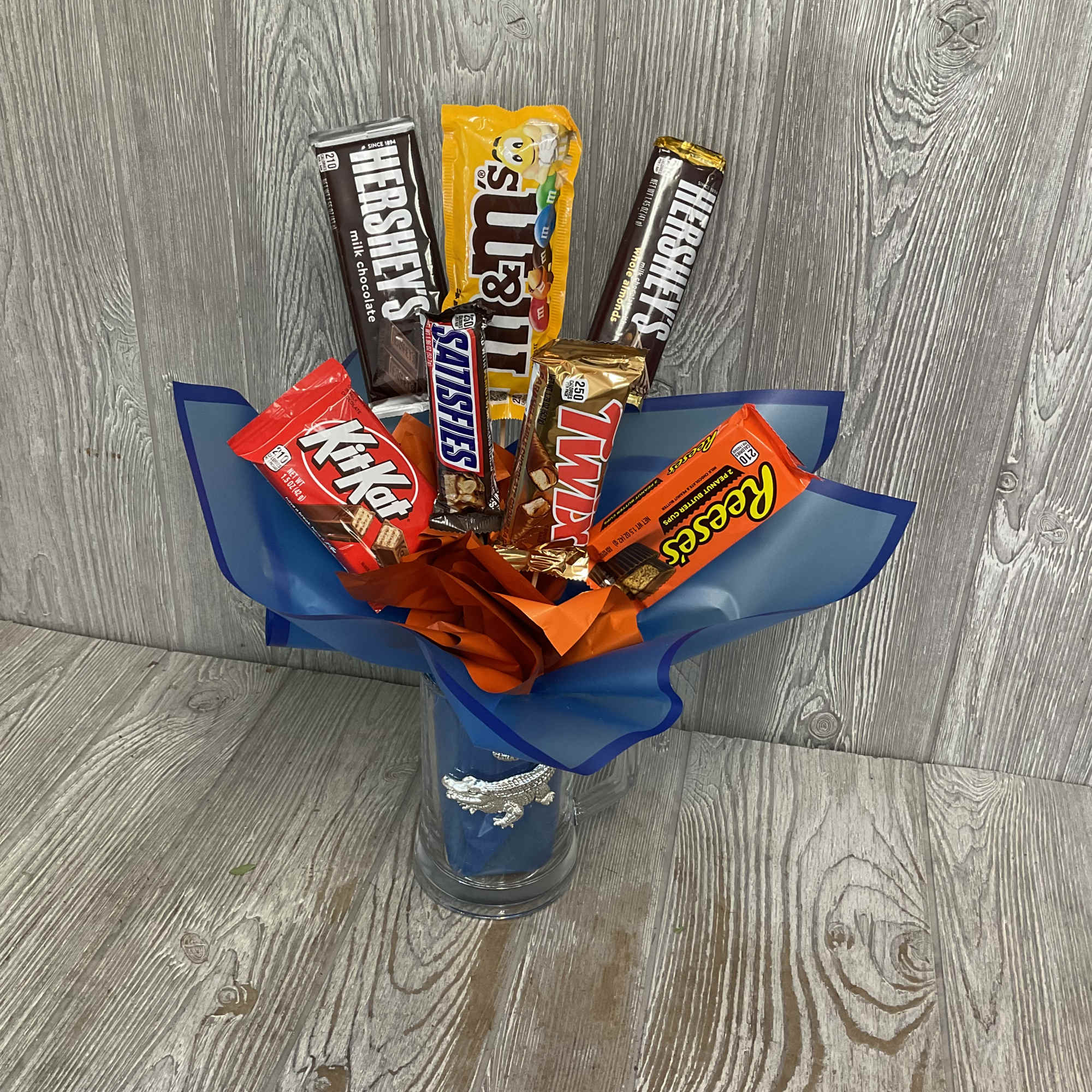 Candy bouquet in a glass vase with assorted chocolate bars and wrapped candy