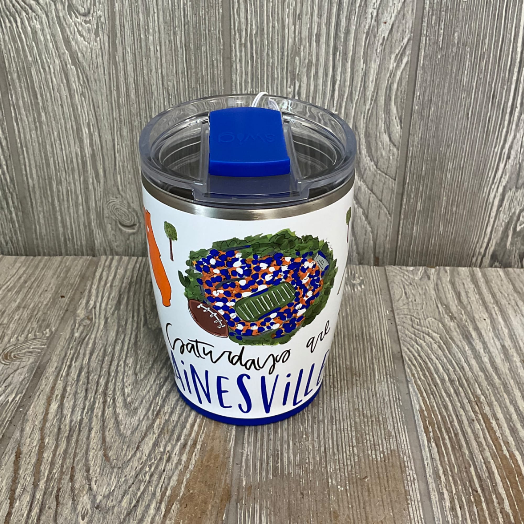 Insulated tumbler with a football-themed design and blue lid