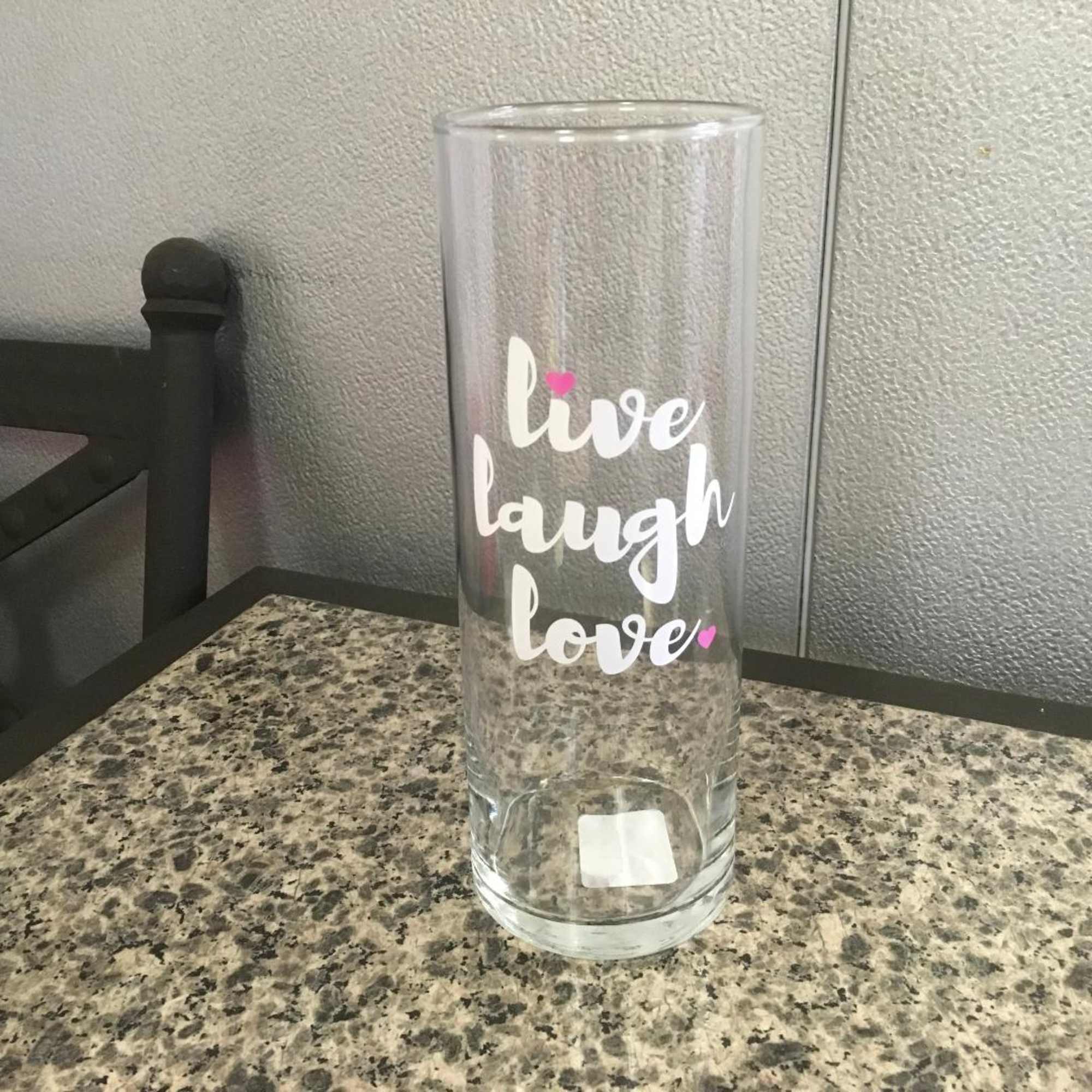 Clear glass vase with "live laugh love" text