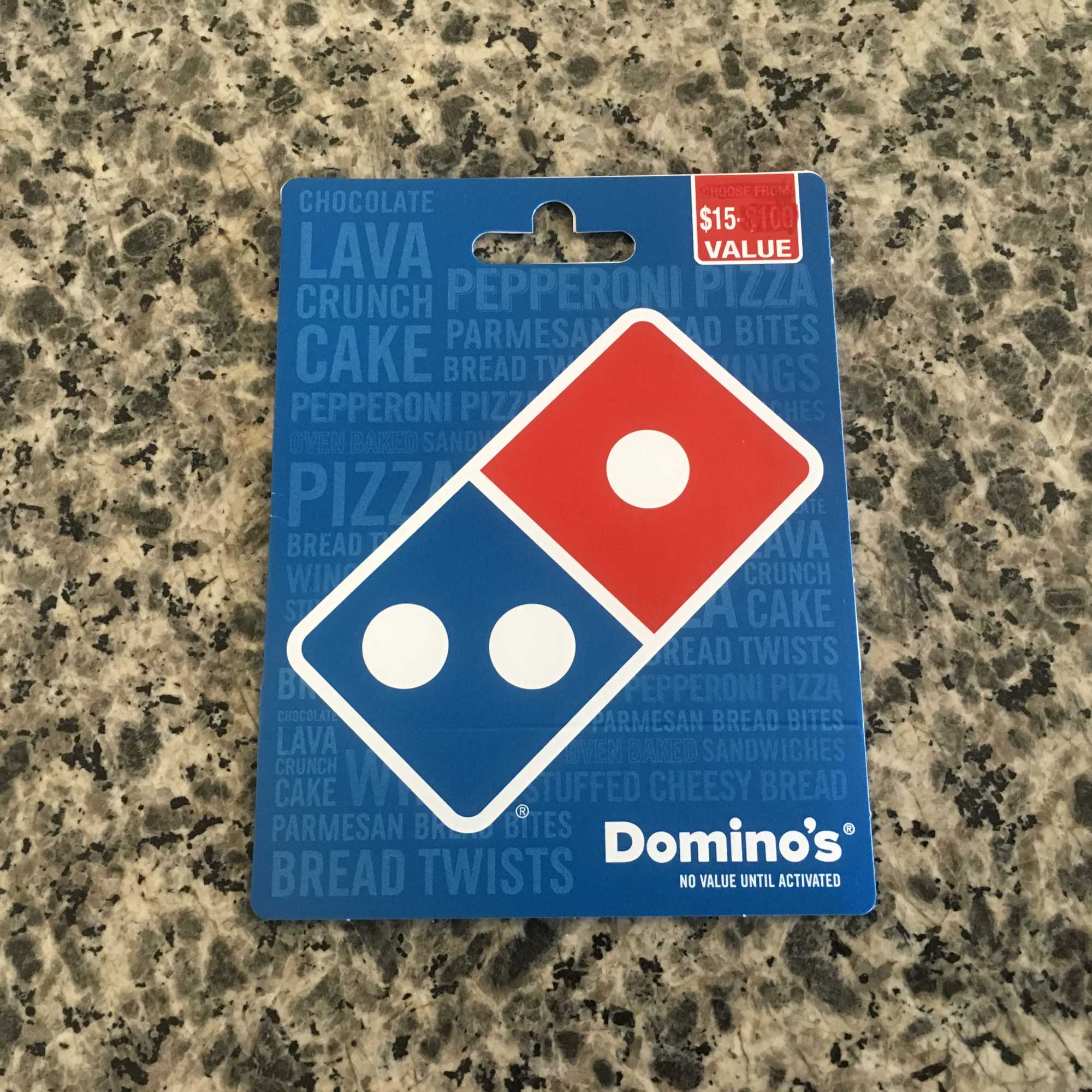 Domino's gift card on a speckled countertop