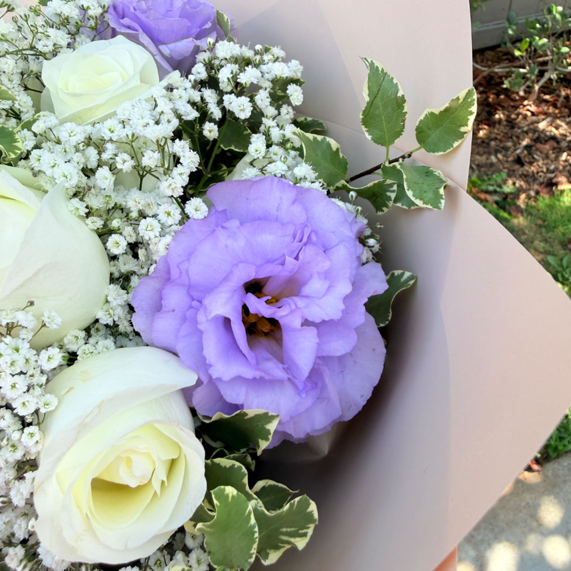 Bouquet of white roses and lavender lisianthus with baby's breath