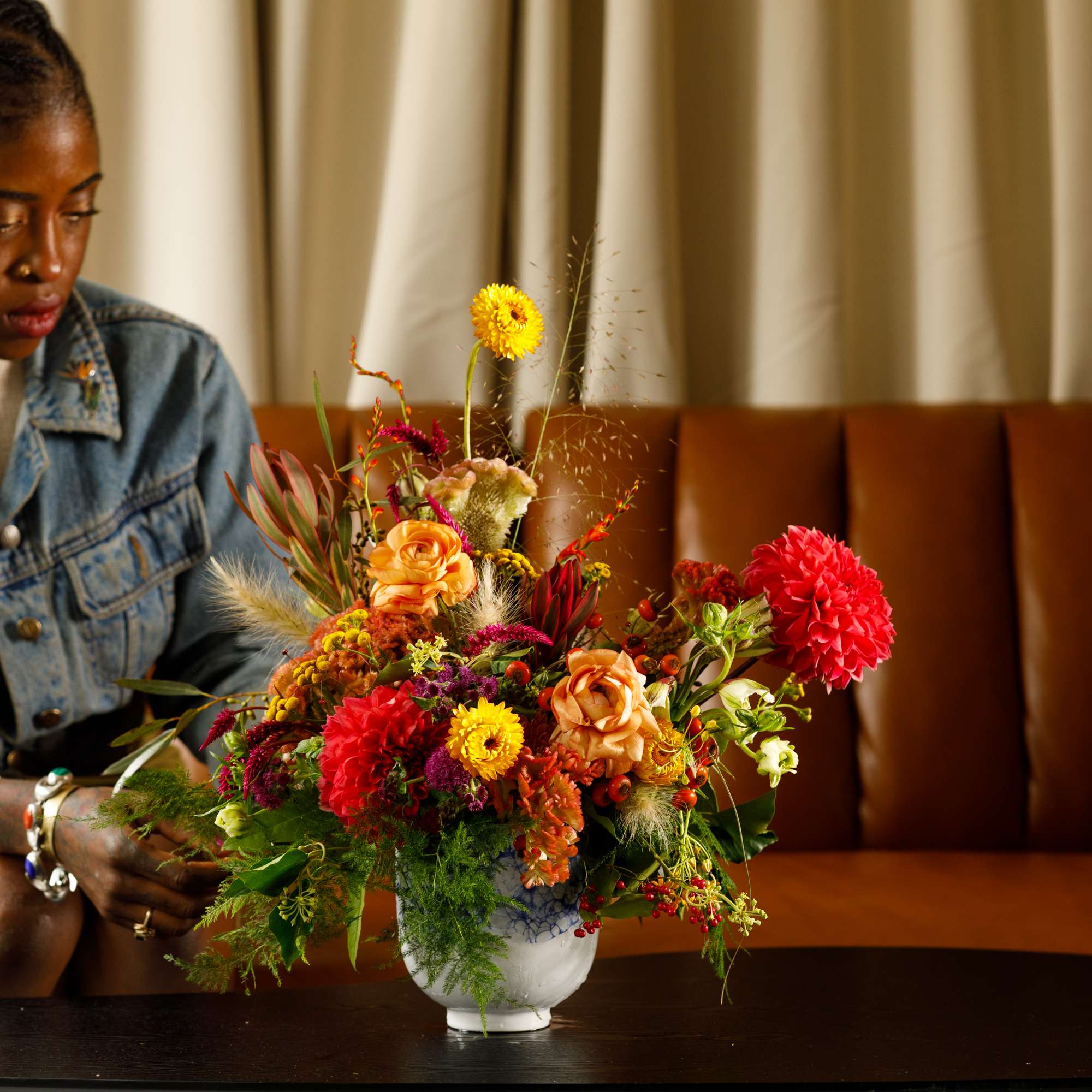 Colorful mixed flower arrangement in a white vase on a table, photo 4 of 8