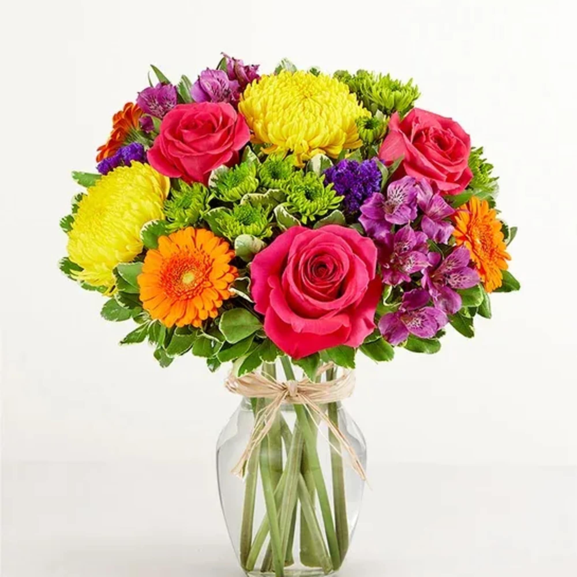 Colorful bouquet of roses, chrysanthemums, gerbera daisies, and alstroemeria in a glass vase