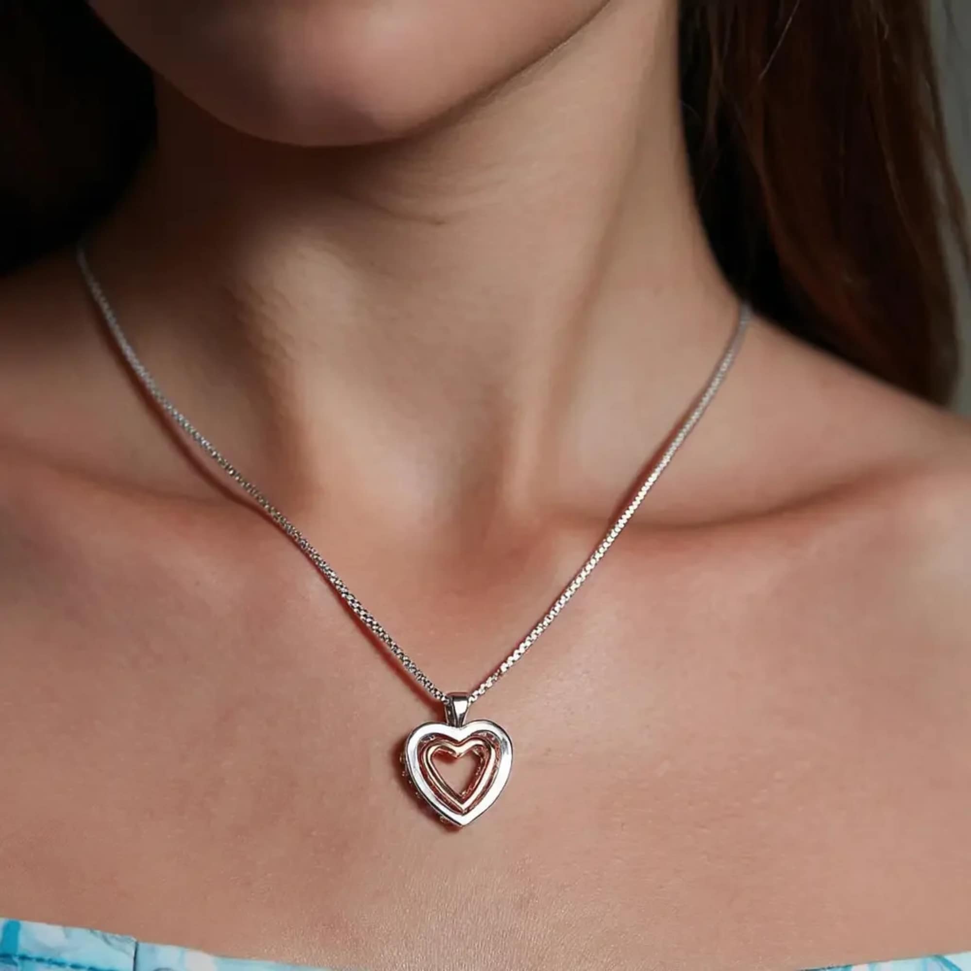Woman wearing a silver heart pendant necklace