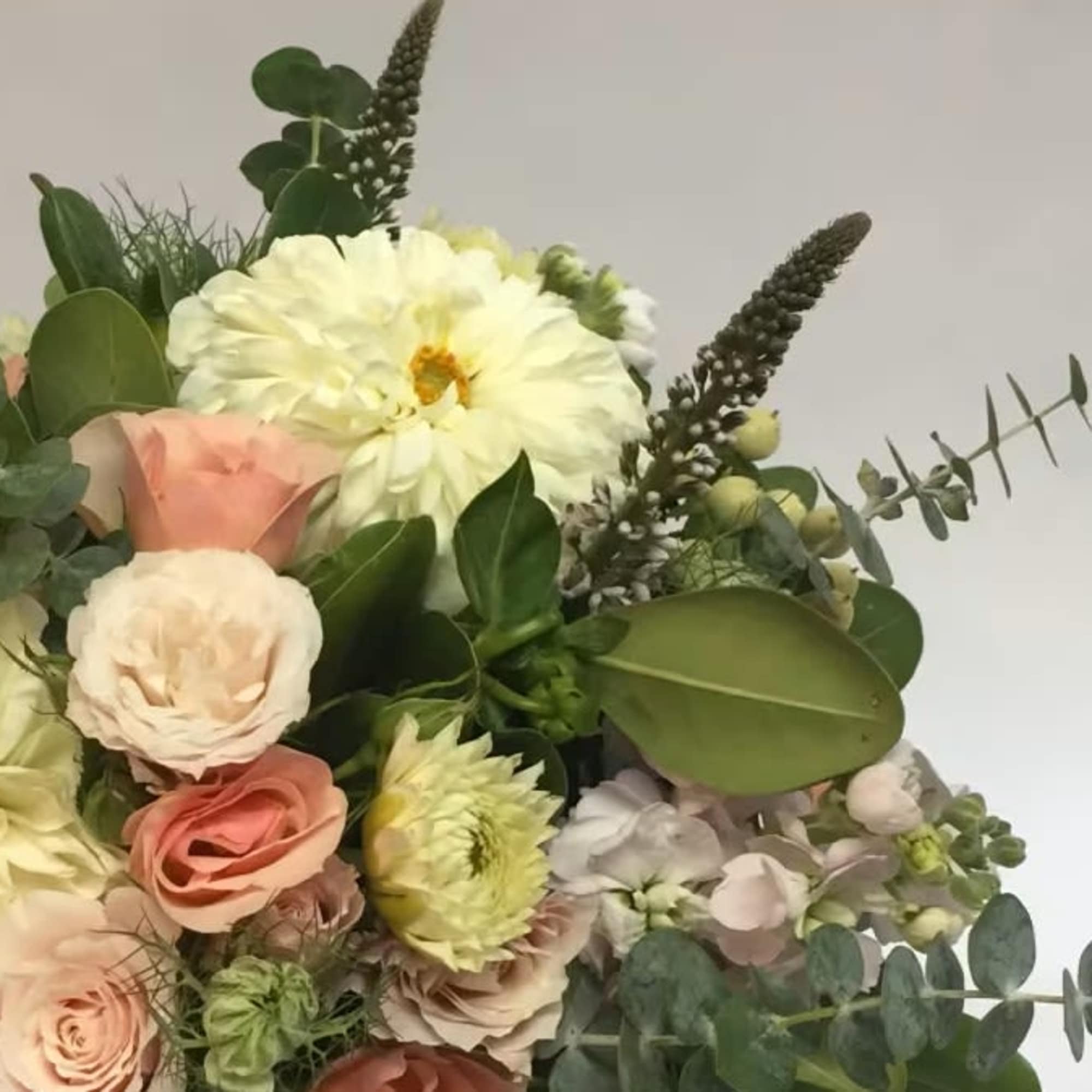 Bouquet of pale roses and white blooms with eucalyptus