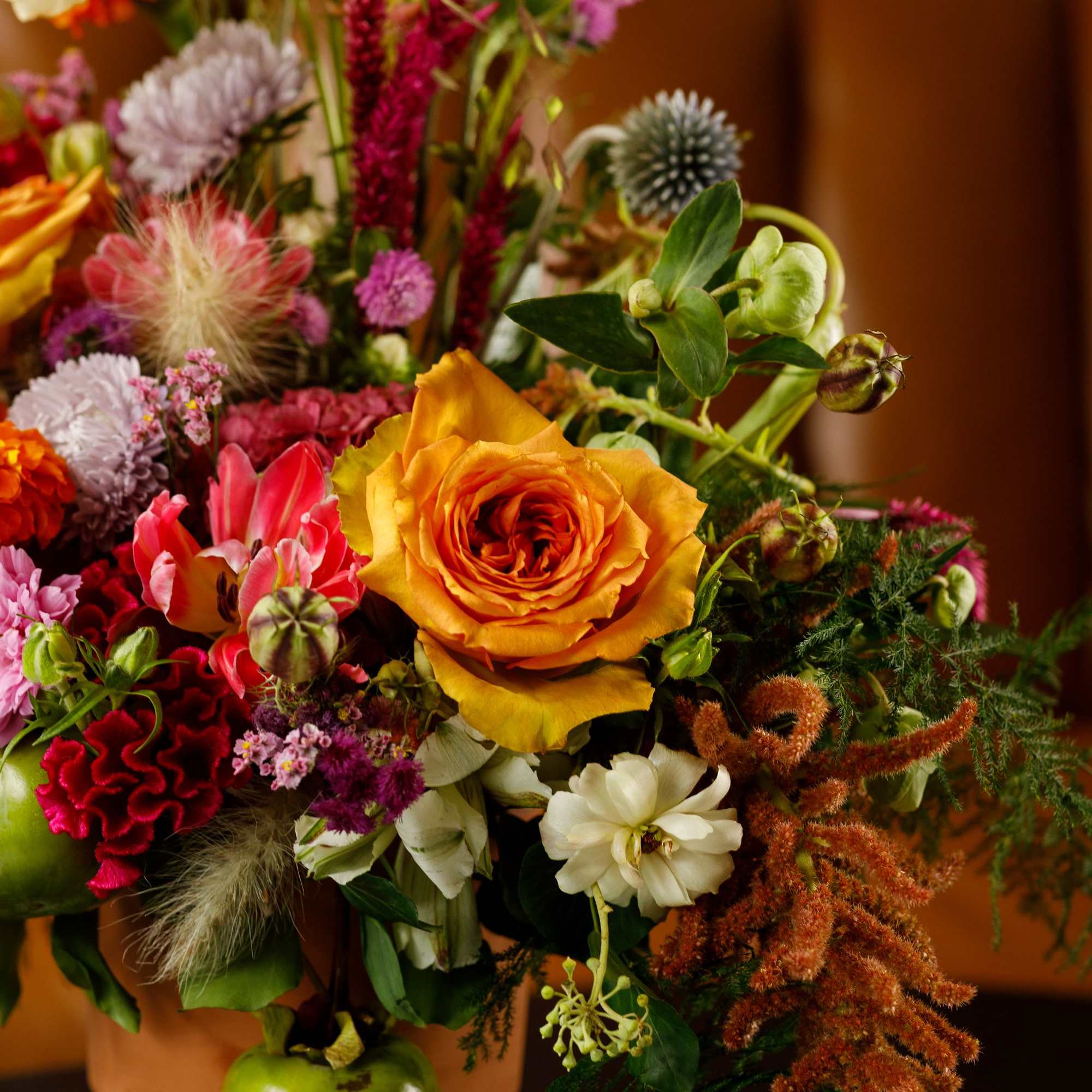 Colorful mixed bouquet with orange and pink flowers in a vase