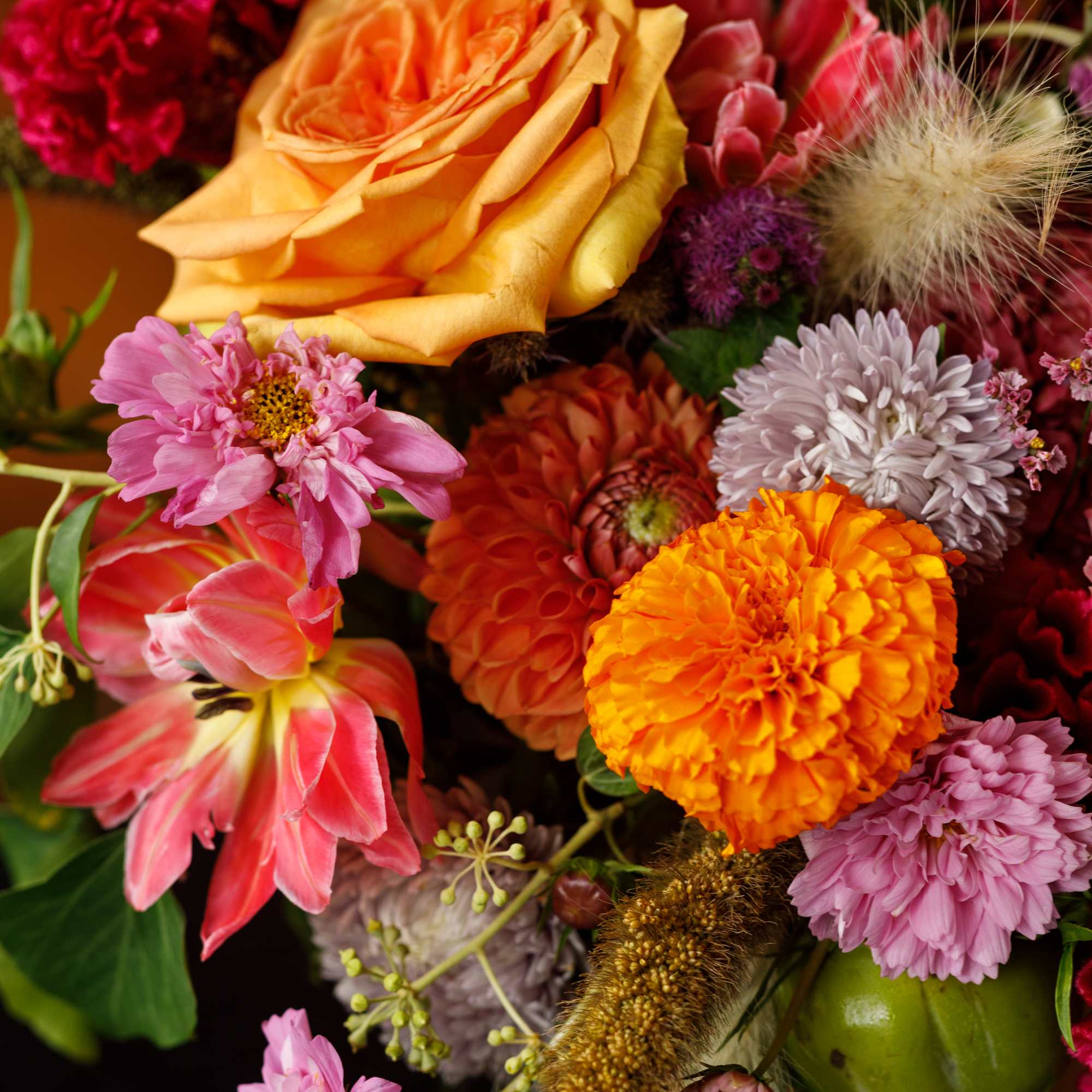 Colorful bouquet with an orange rose and mixed blooms