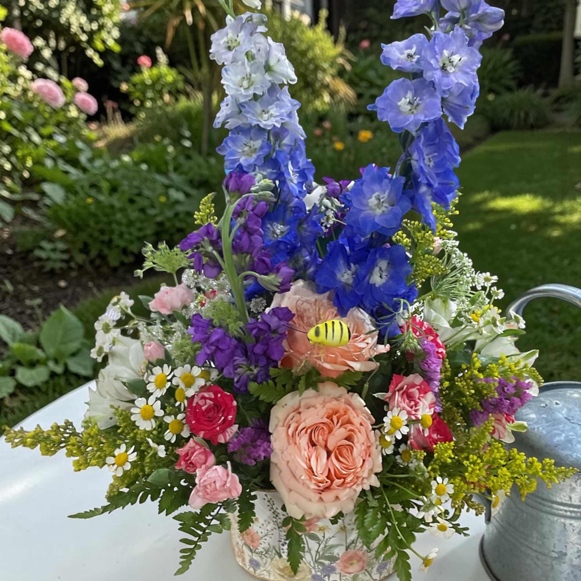 Celebrate with our charming Fluttering Wildflower garden arrangement from Aspen Tower Florist