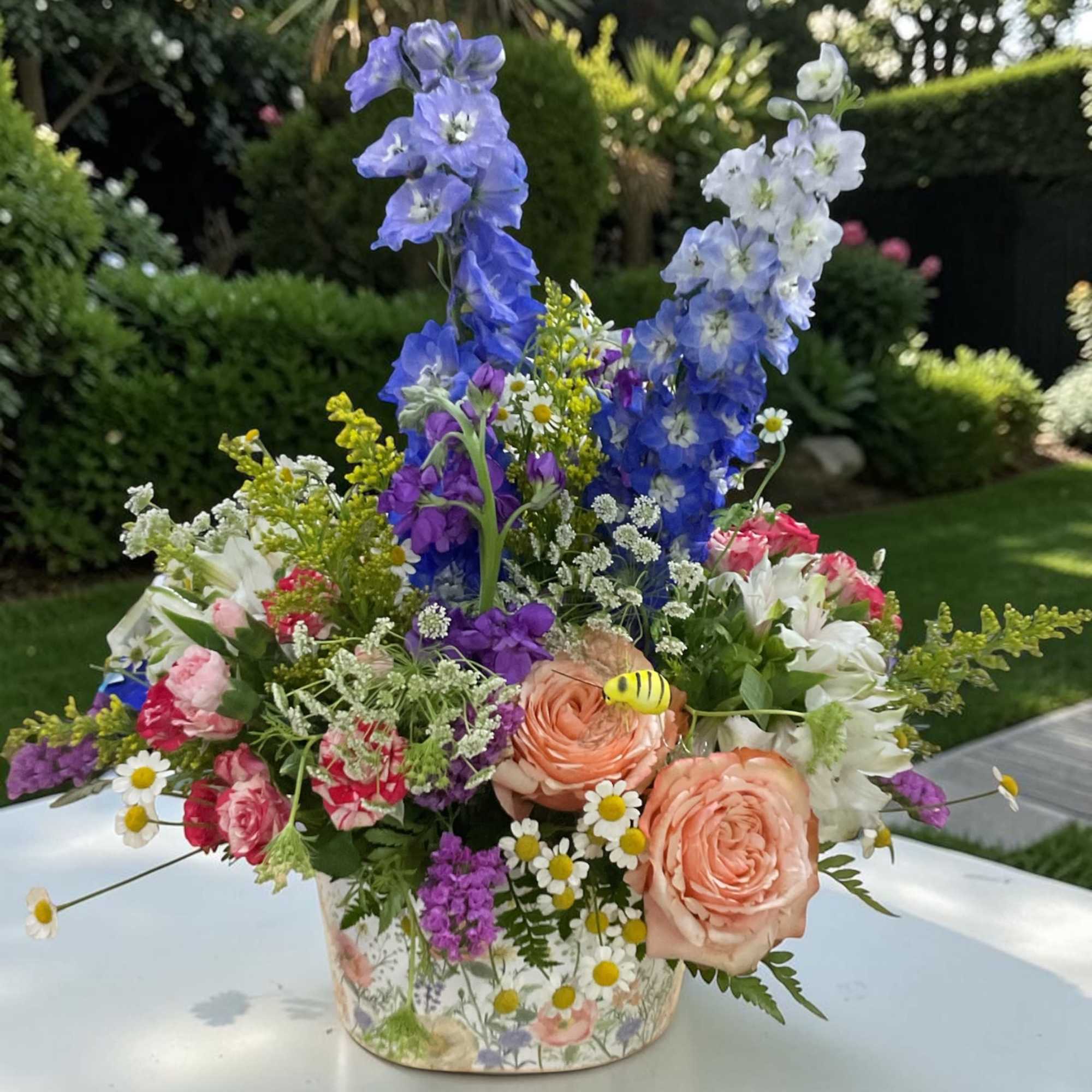 Celebrate with our charming Fluttering Wildflower garden arrangement from Aspen Tower Florist