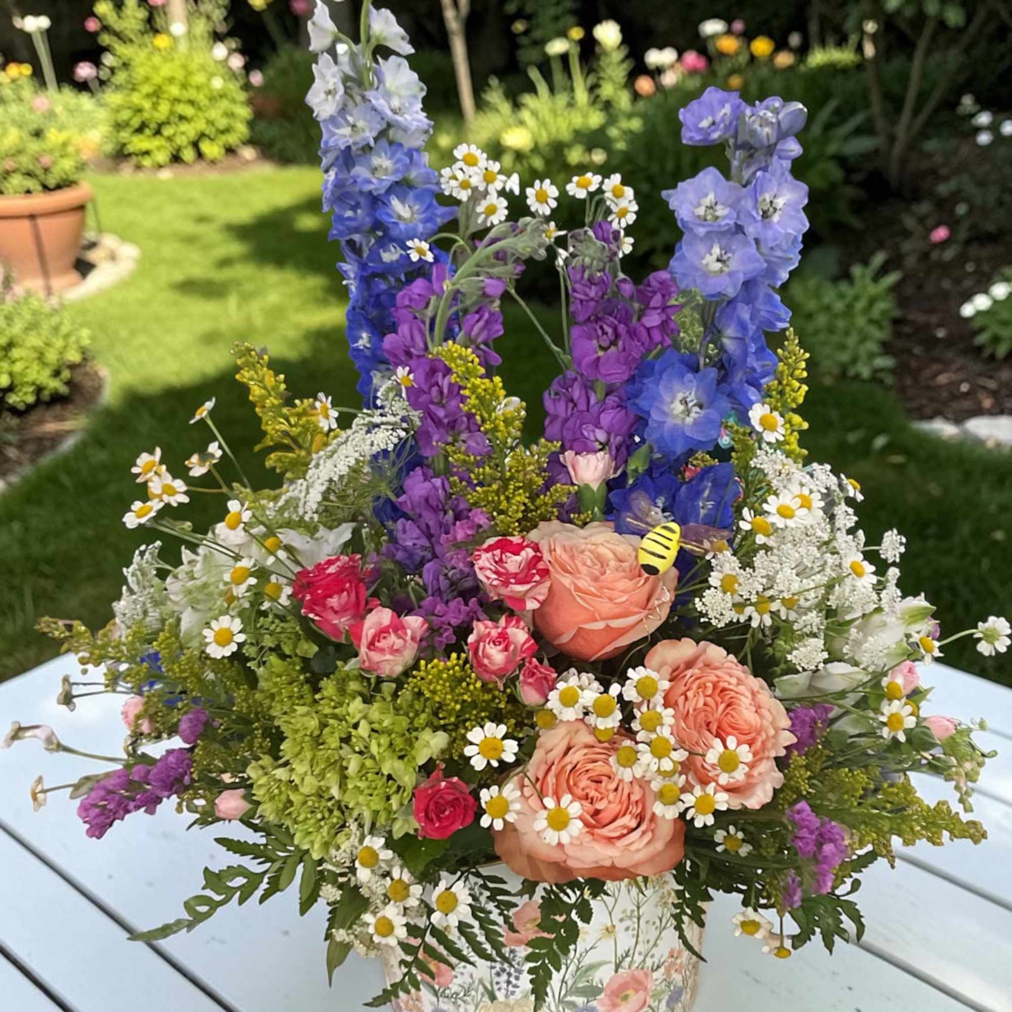 Celebrate with our charming Fluttering Wildflower garden arrangement from Aspen Tower Florist