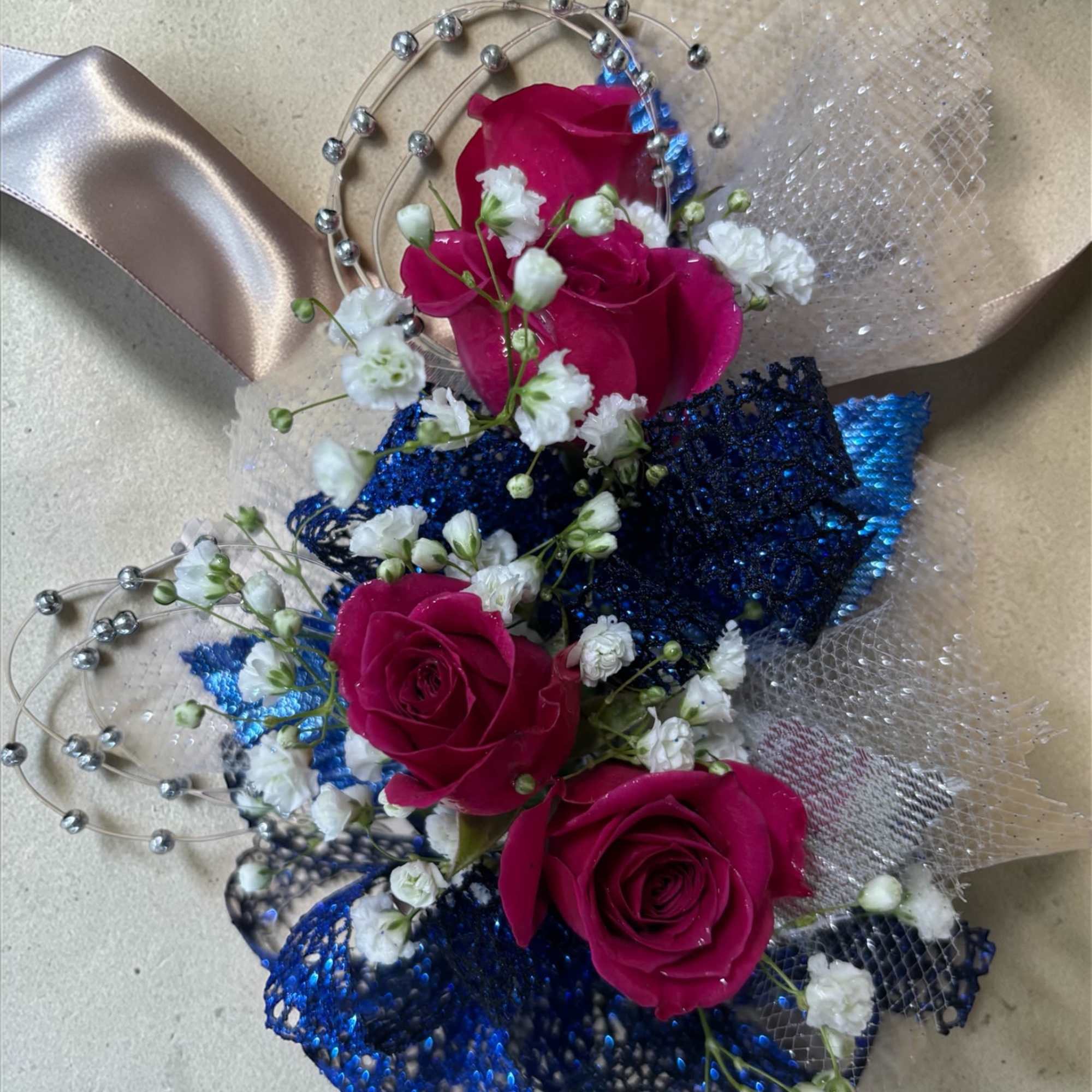 Fuchsia Nights &ndash; Corsage Only

Vibrant fuchsia roses, royal blue ribbon, silver accents