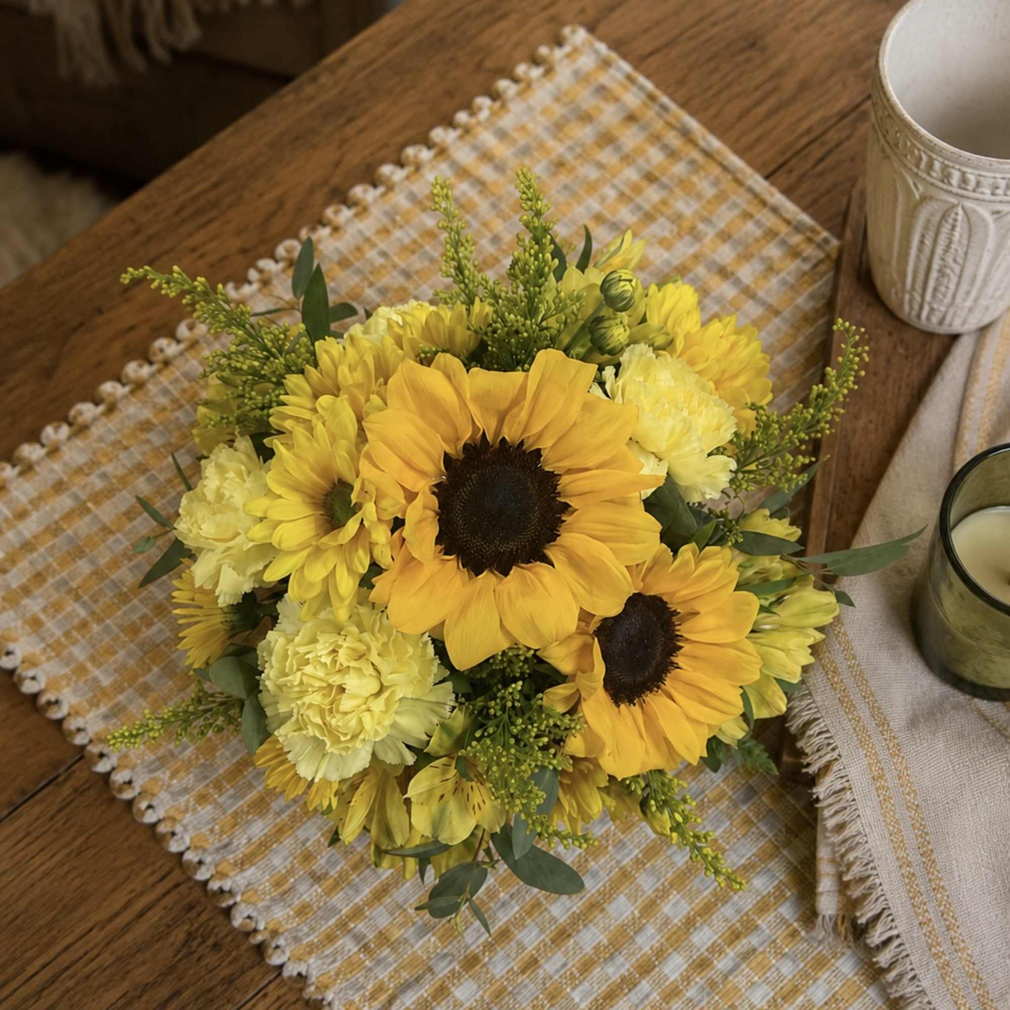 Yellow sunflower and carnation bouquet on a table