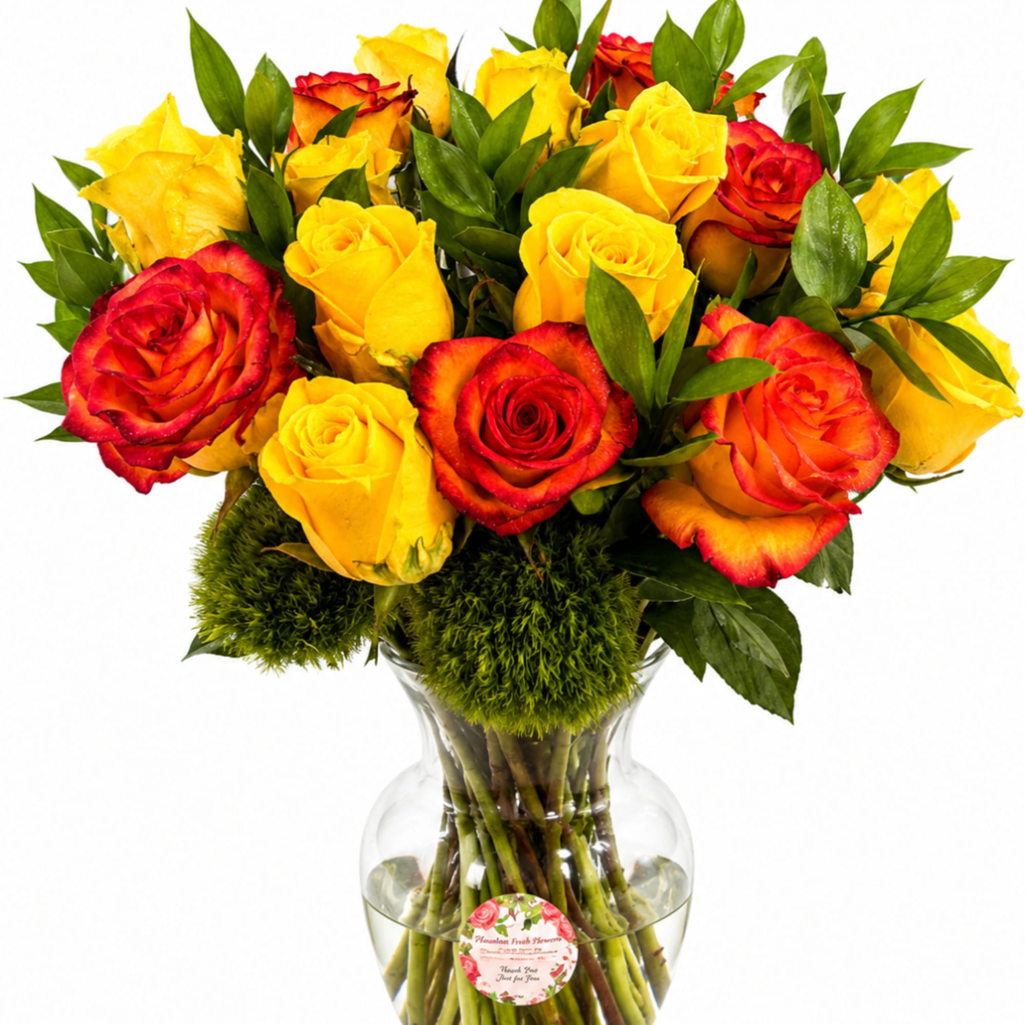 Bouquet of yellow and red roses in a clear glass vase