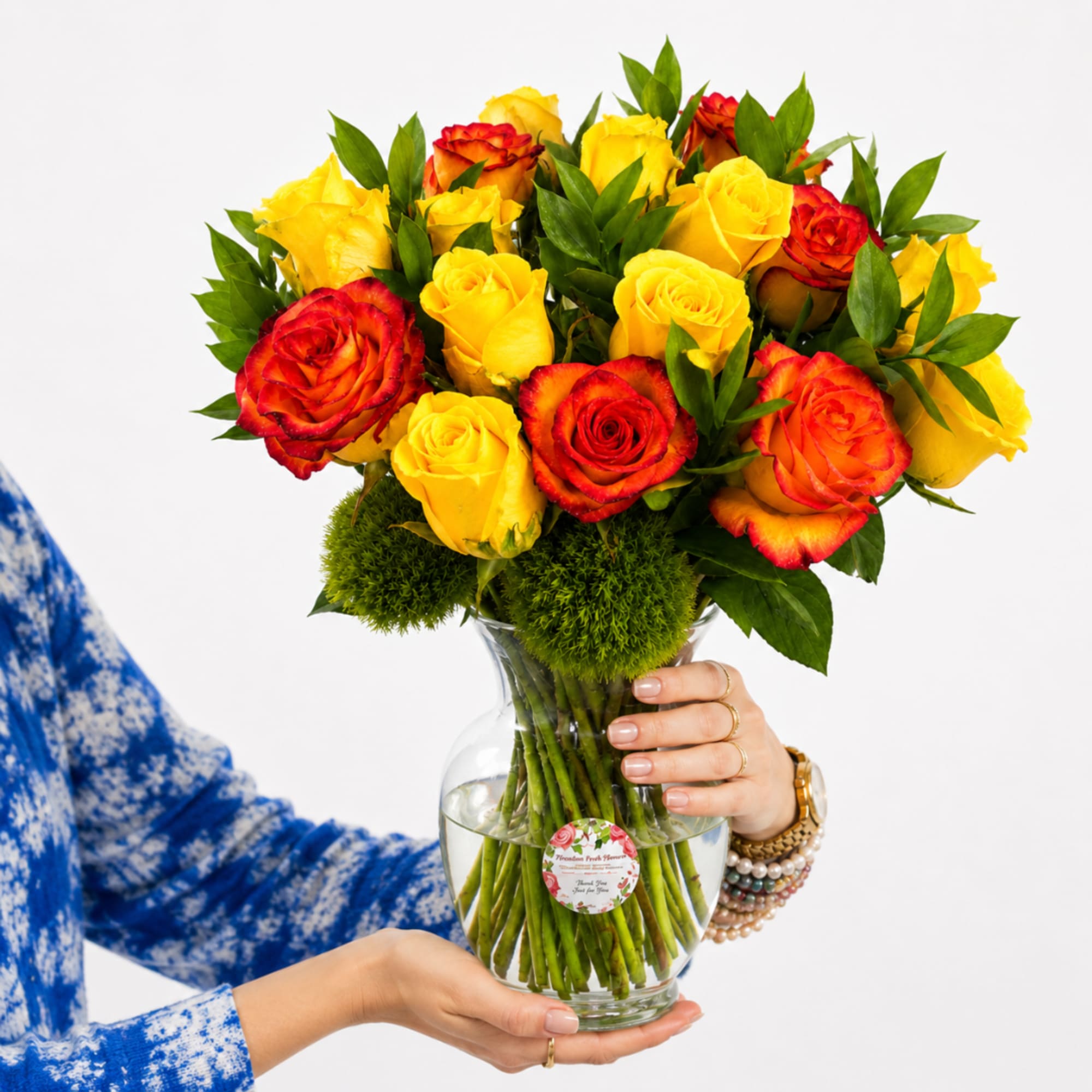 Bouquet of yellow and red roses in a clear glass vase, photo 2 of 3