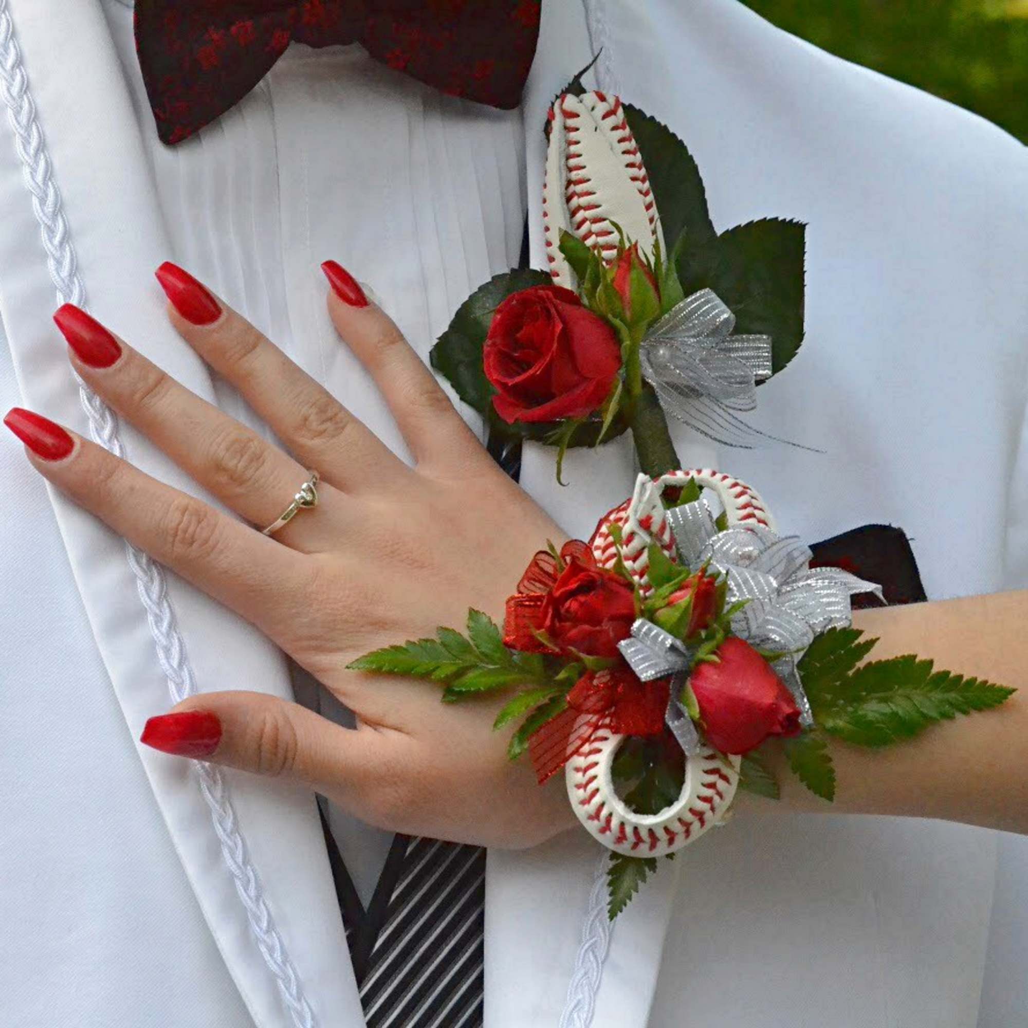 Red rose boutonniere and wrist corsage with baseball accents