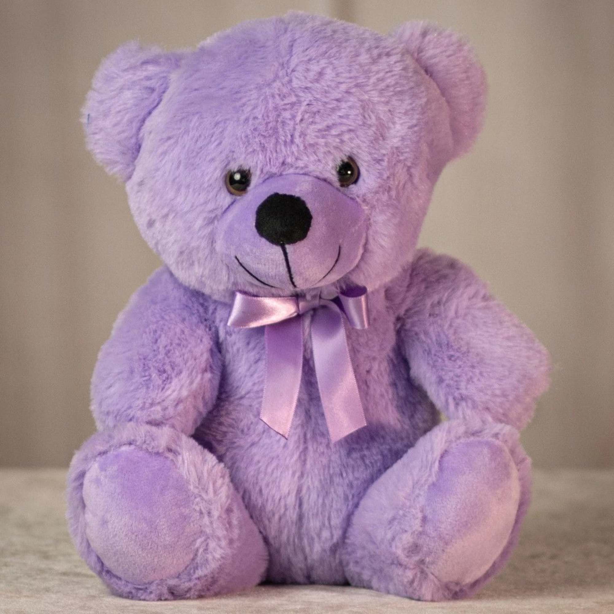 Lavender teddy bear with a satin ribbon bow