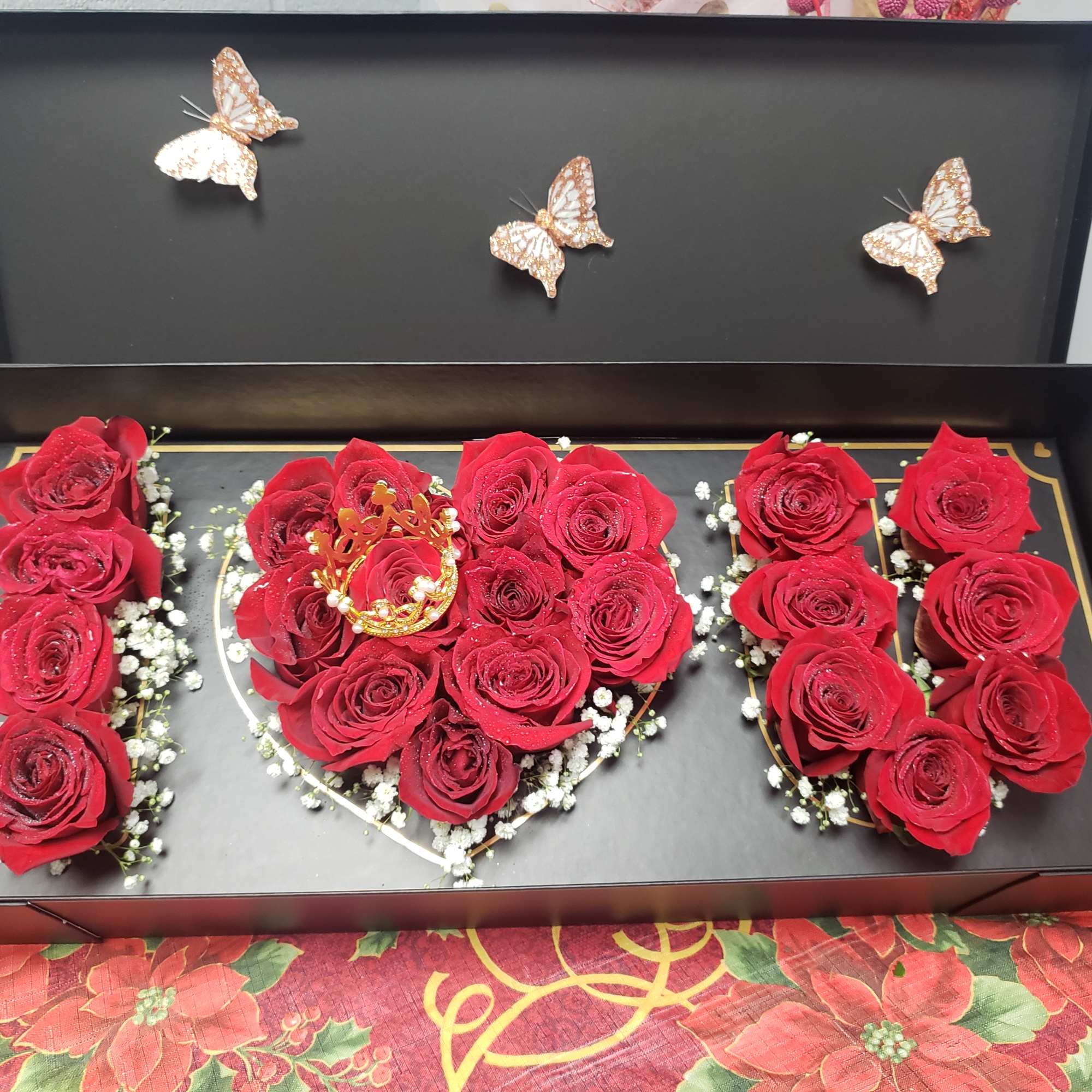 Red roses arranged in a black gift box with butterfly decorations, photo 2 of 2