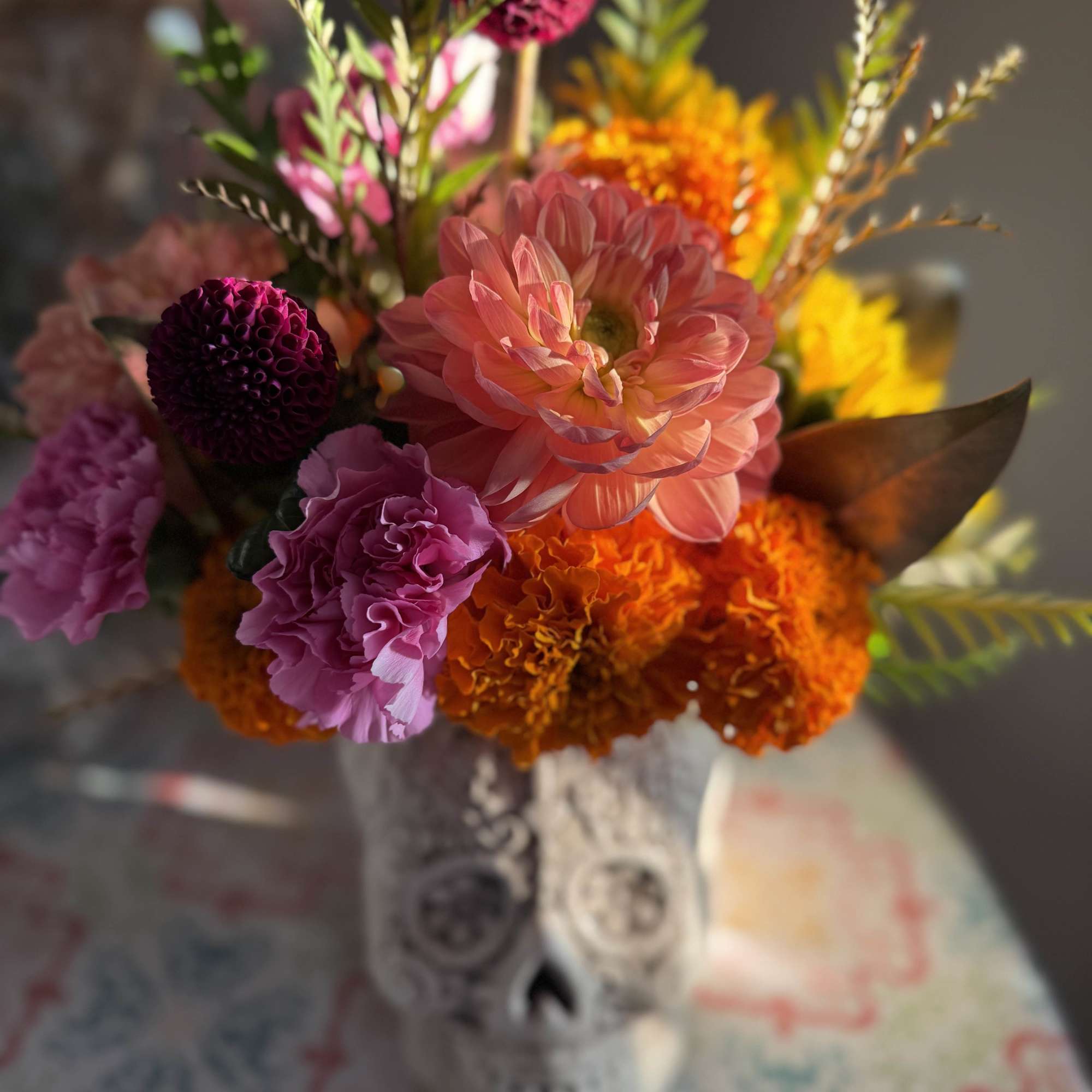 Colorful bouquet in a decorative skull vase