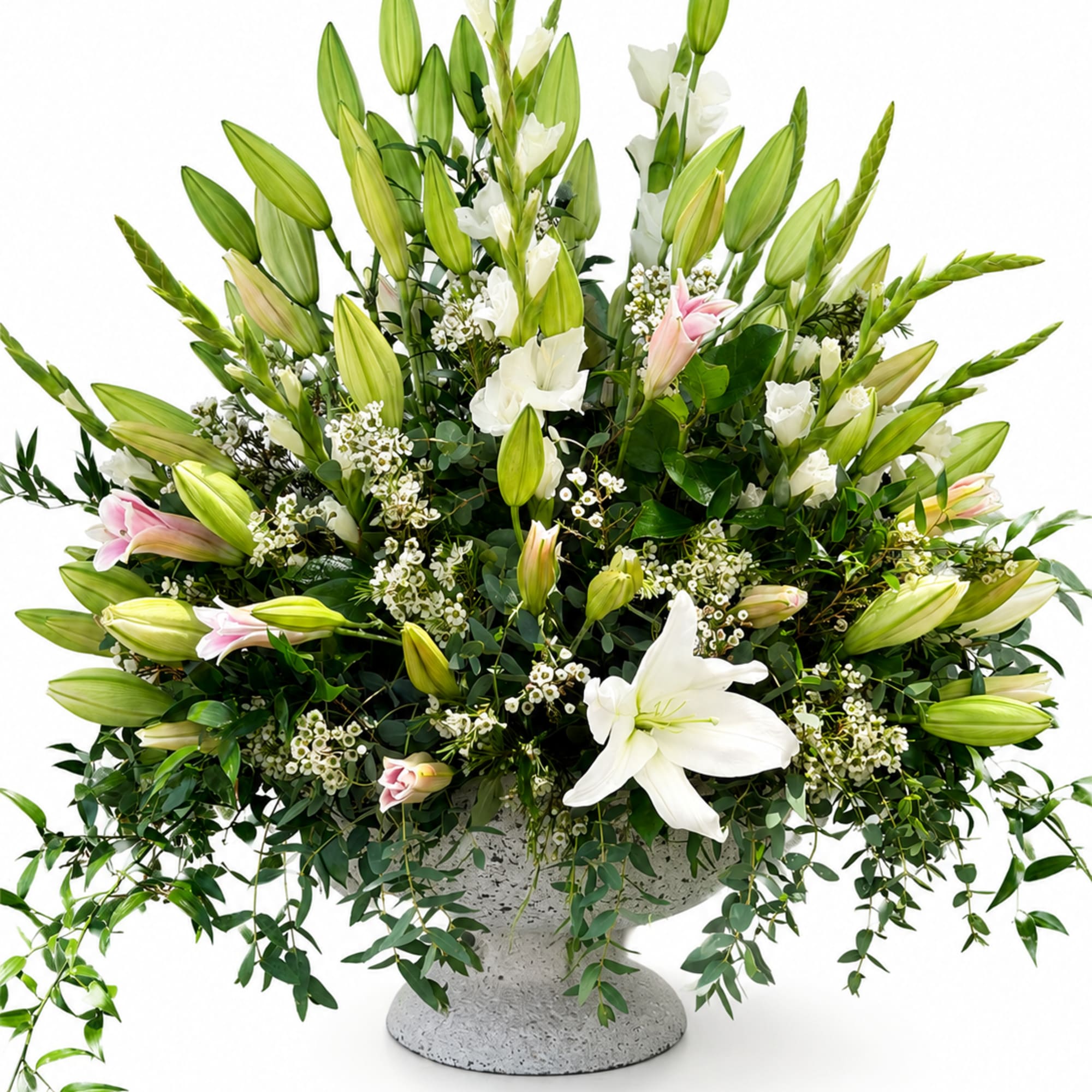 A lush arrangement of Oriental lilies, gladiolus, waxflower, and cascading greenery, beautifully