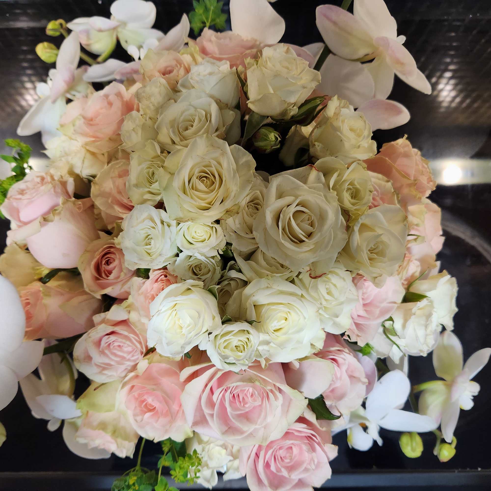 Bouquet of cream and pink roses with white orchids