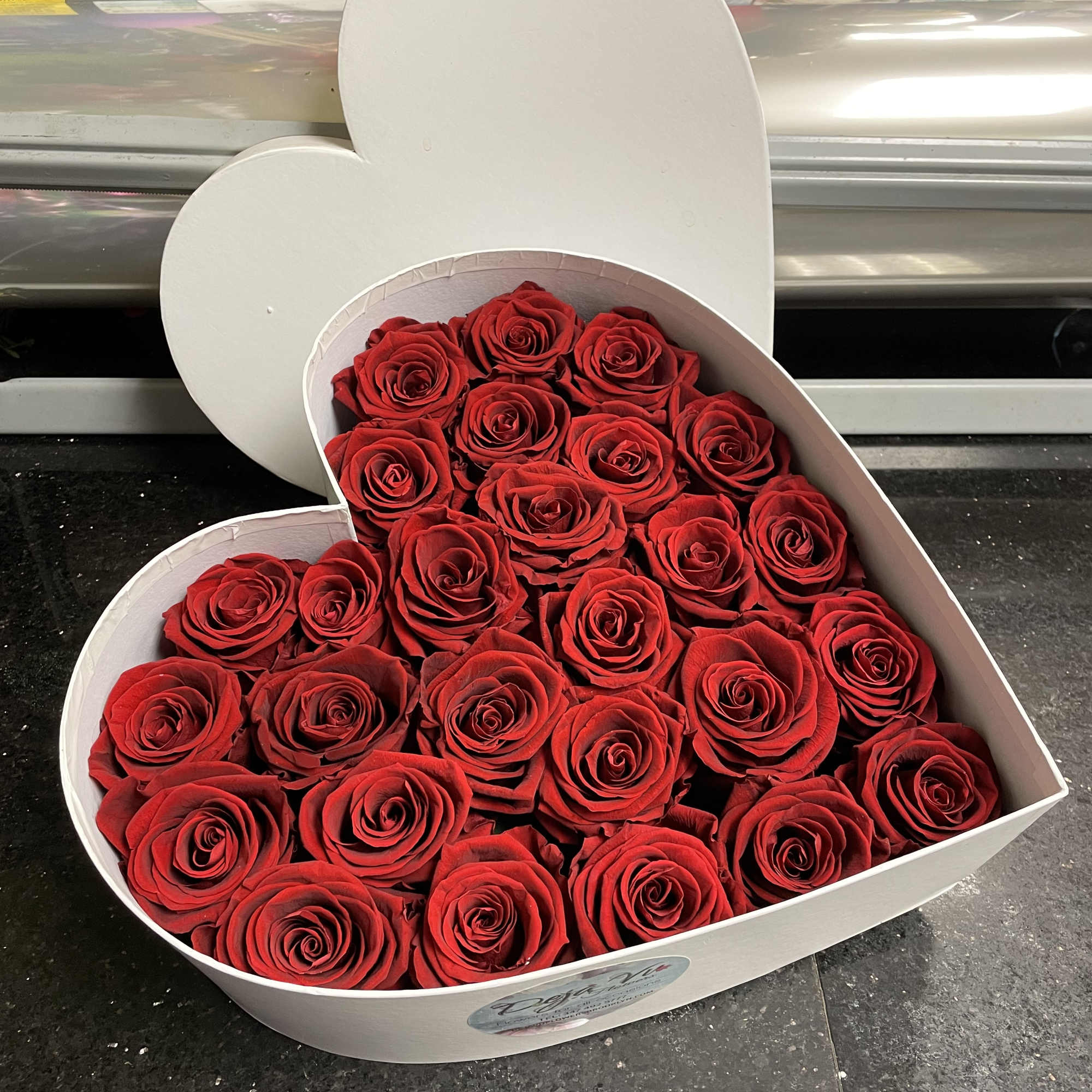 Heart-shaped box filled with red roses