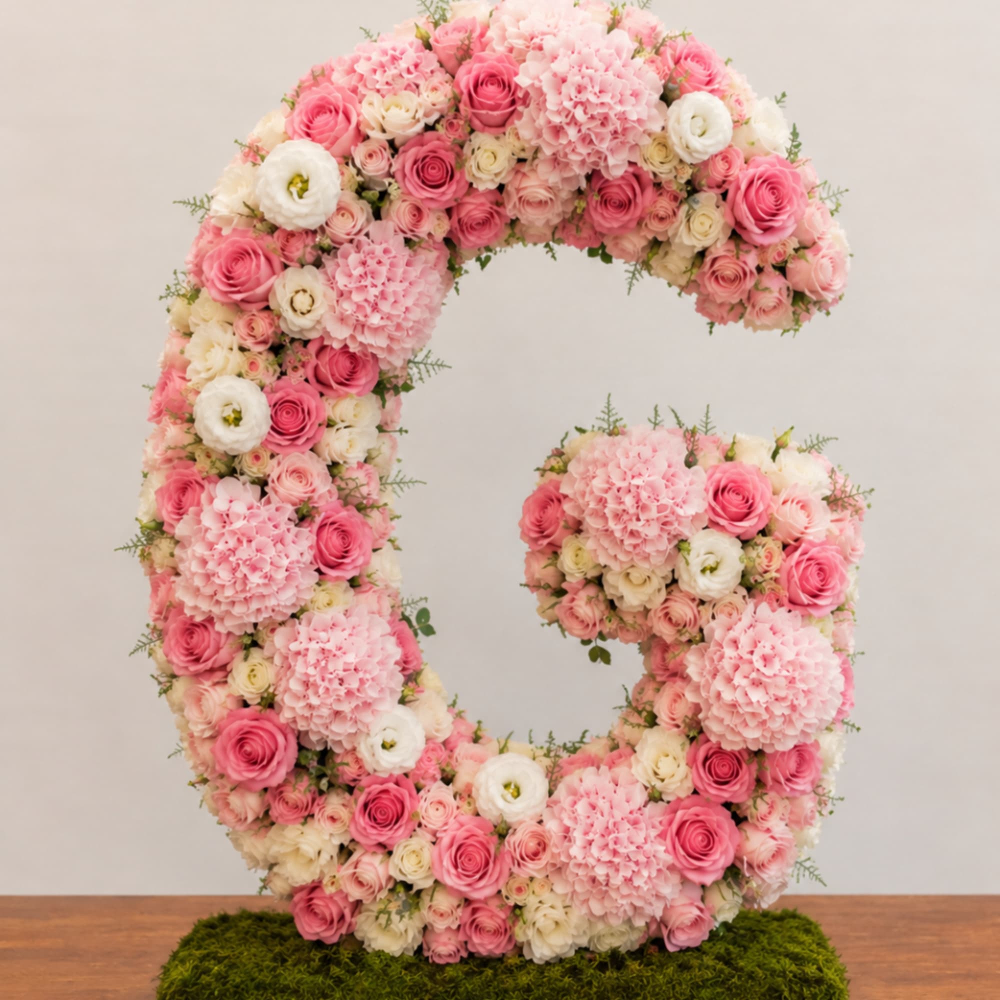 Large floral letter G made of pink and white roses and hydrangeas
