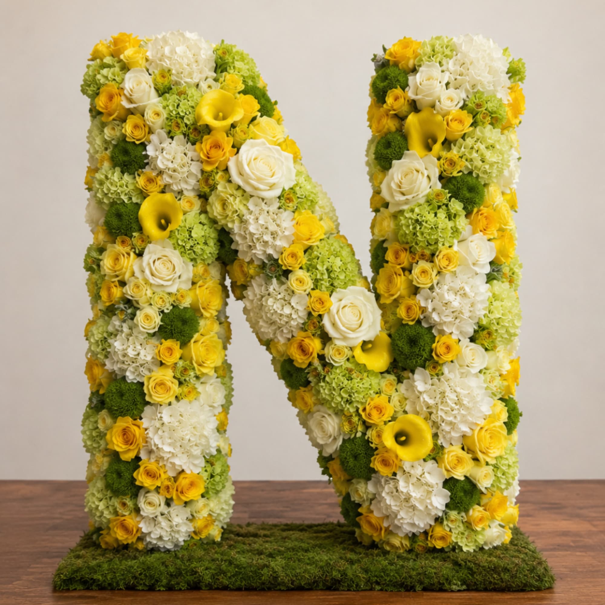 Large floral letter N covered in yellow, white, and green flowers