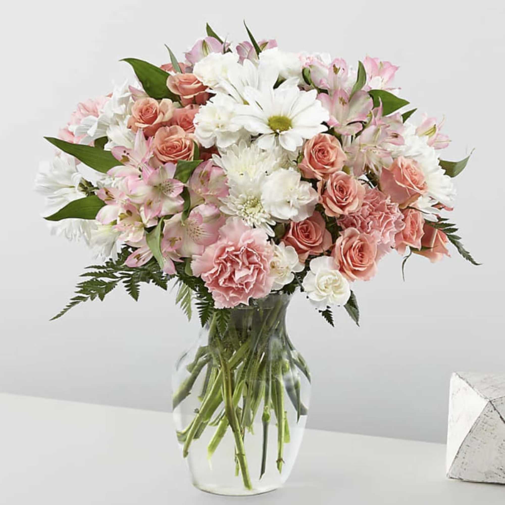 Pink and white mixed bouquet in a clear glass vase