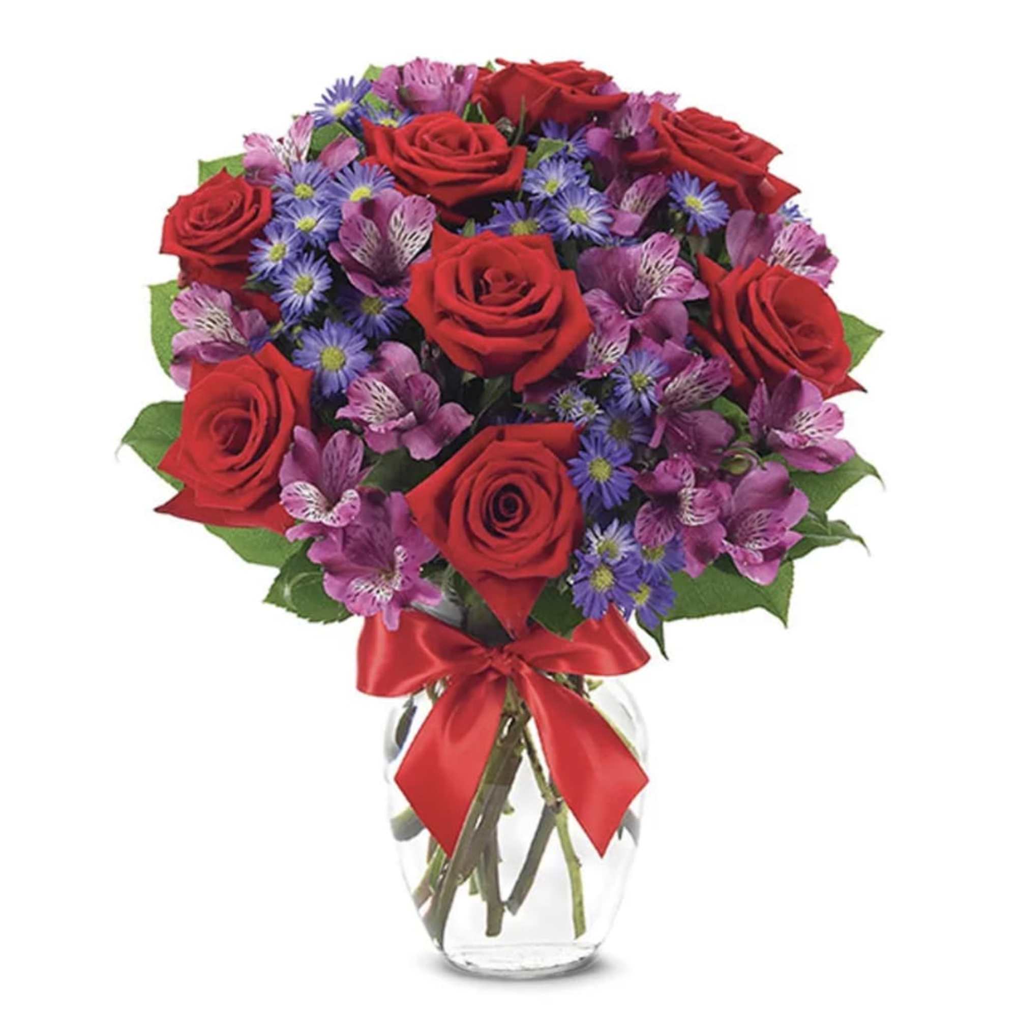 Bouquet of red roses and purple flowers in a clear glass vase with a red ribbon