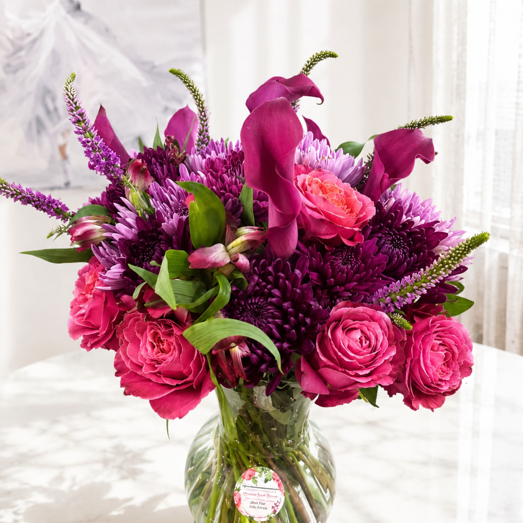 A graceful blend of rich jewel tones and soft romantic blooms, this