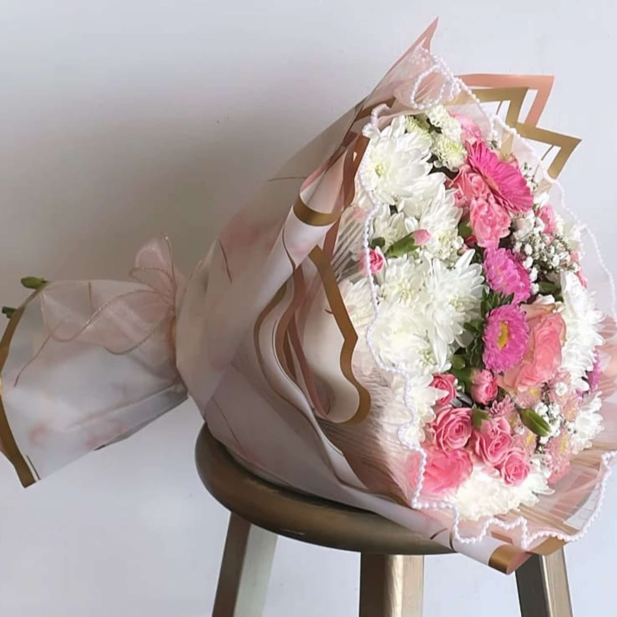 Pink and white mixed bouquet wrapped in blush paper