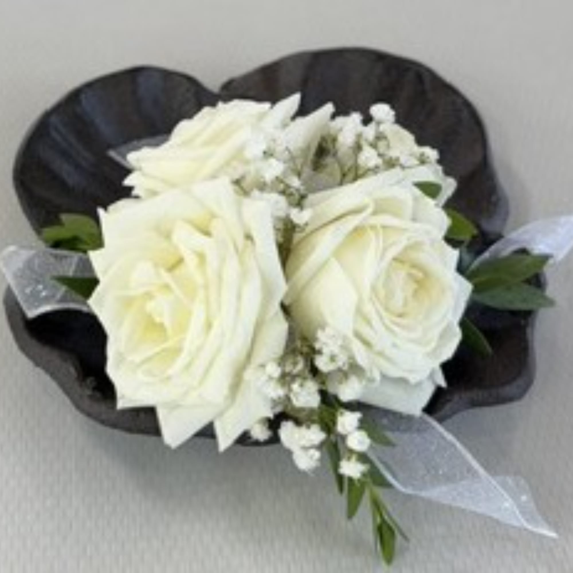 White rose bouquet with baby's breath and black wrapping