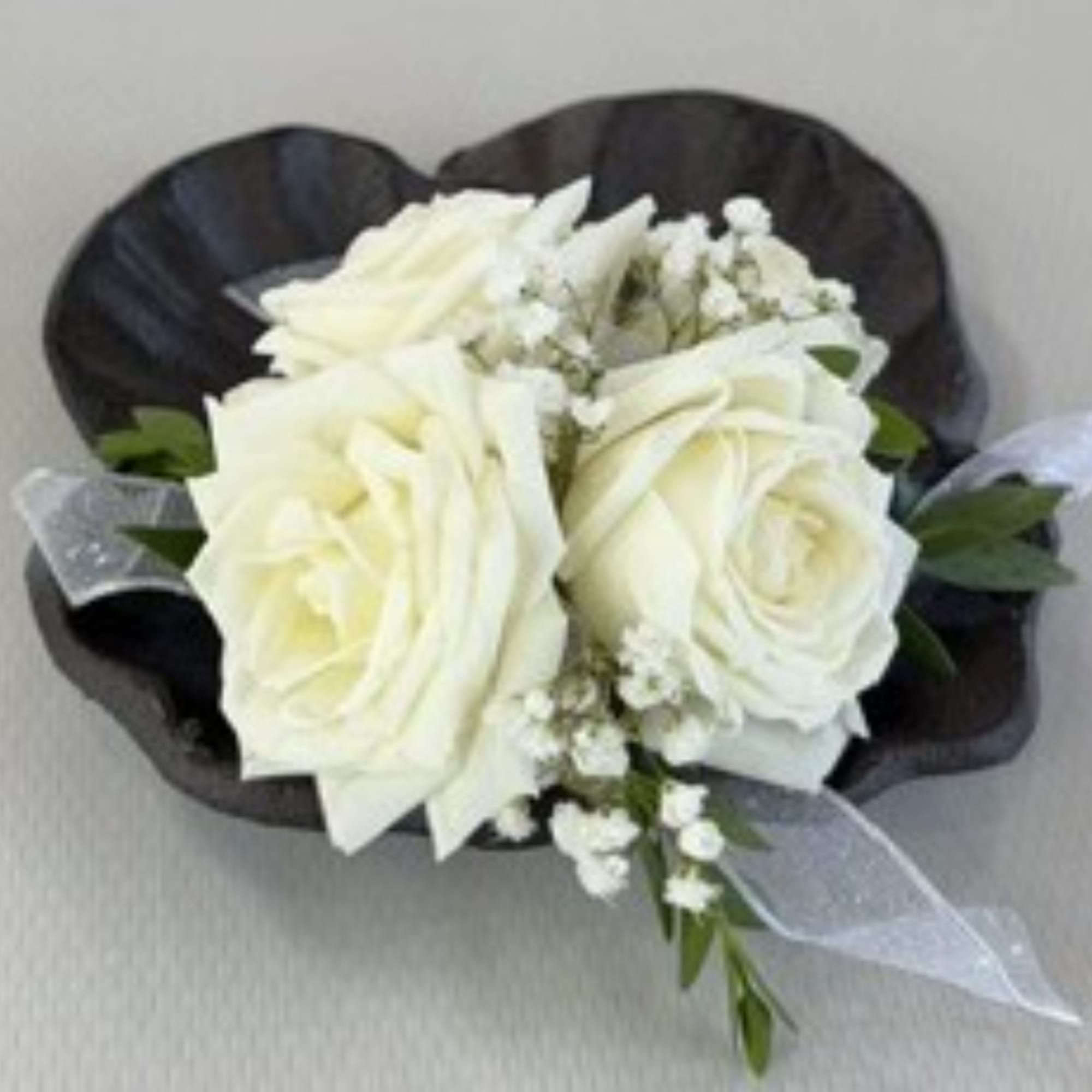 White rose bouquet with baby's breath and black wrapping
