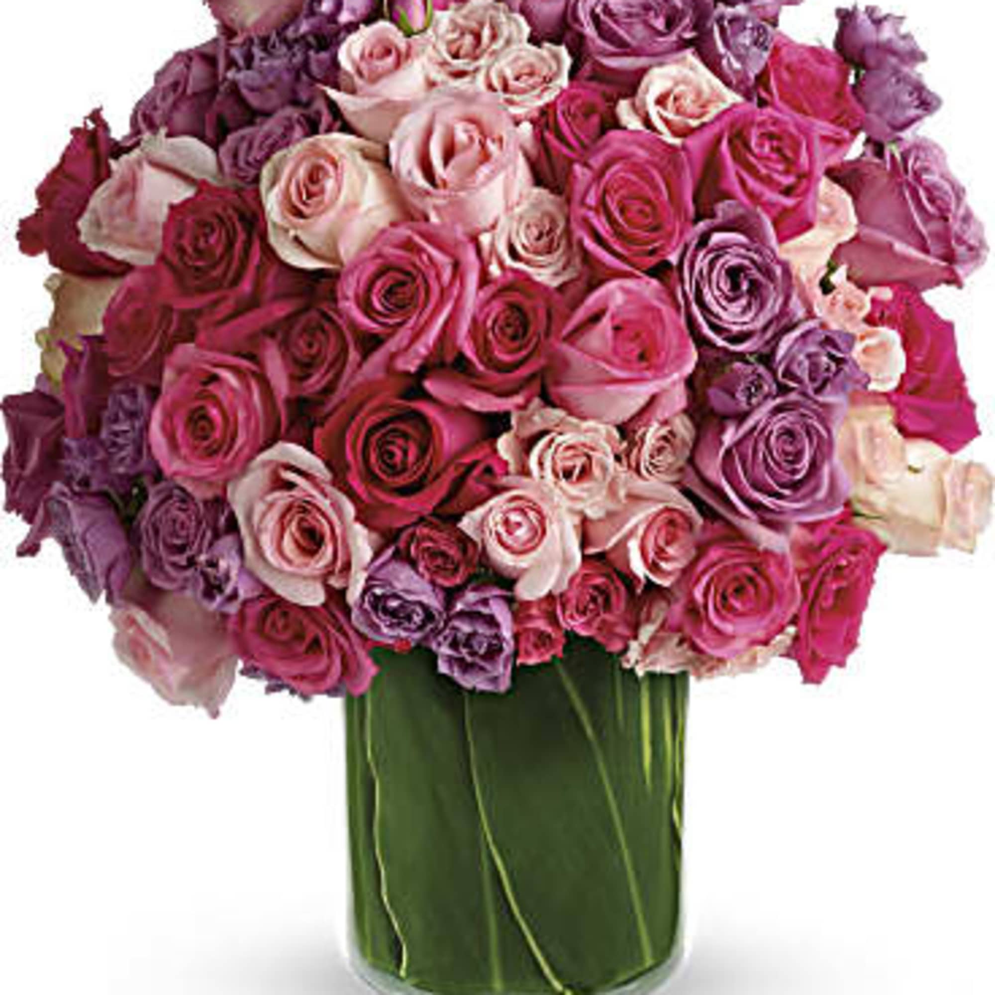 Bouquet of pink and purple roses in a clear glass vase