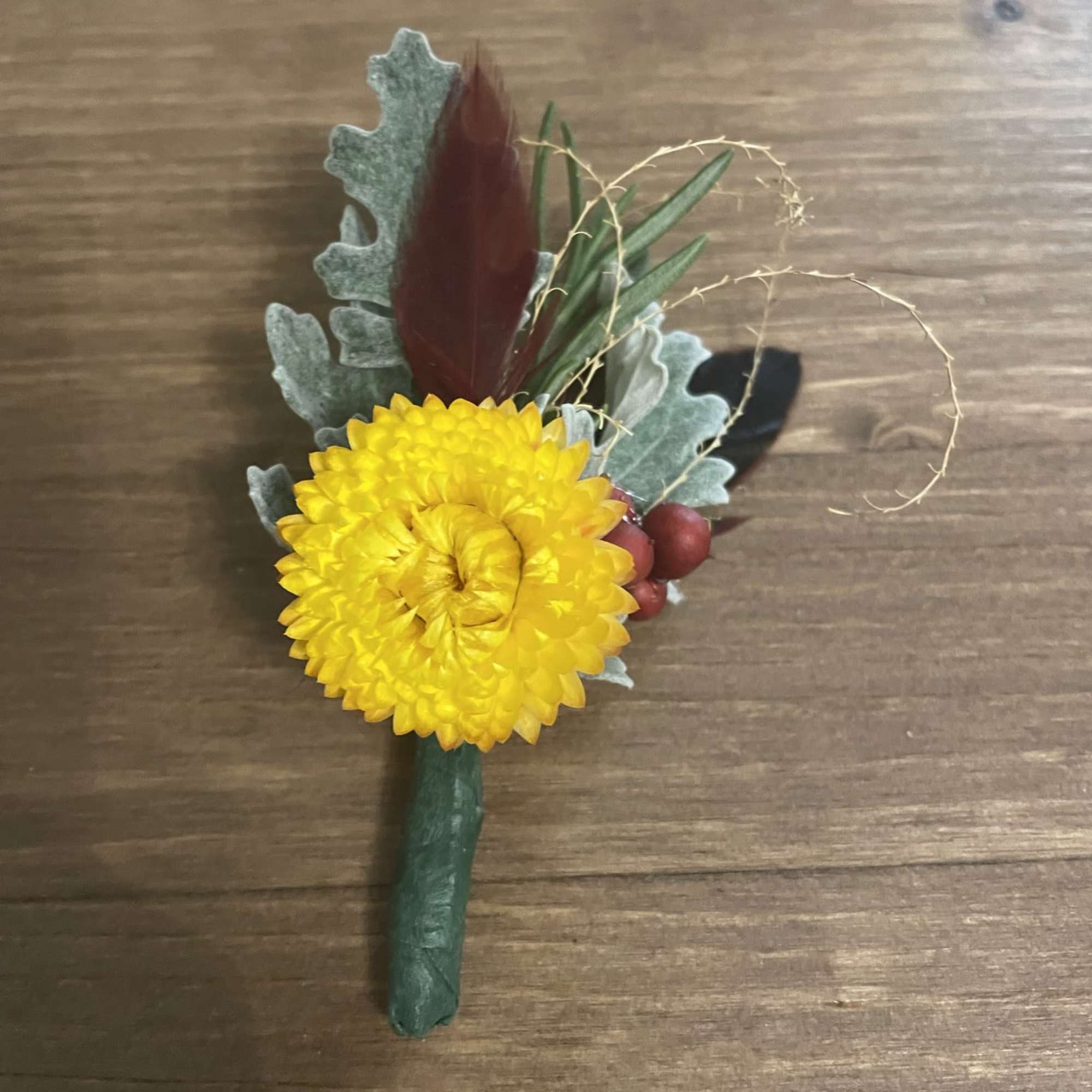 Yellow chrysanthemum boutonniere with berries and foliage