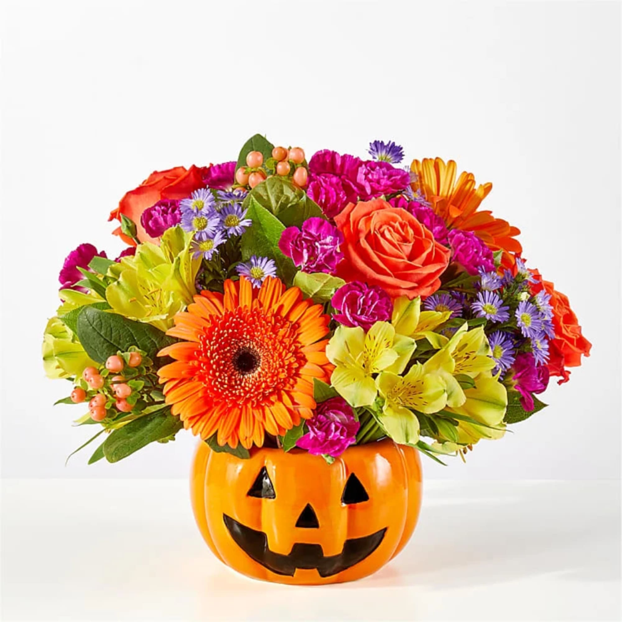 Colorful flower arrangement in a jack-o'-lantern pumpkin container