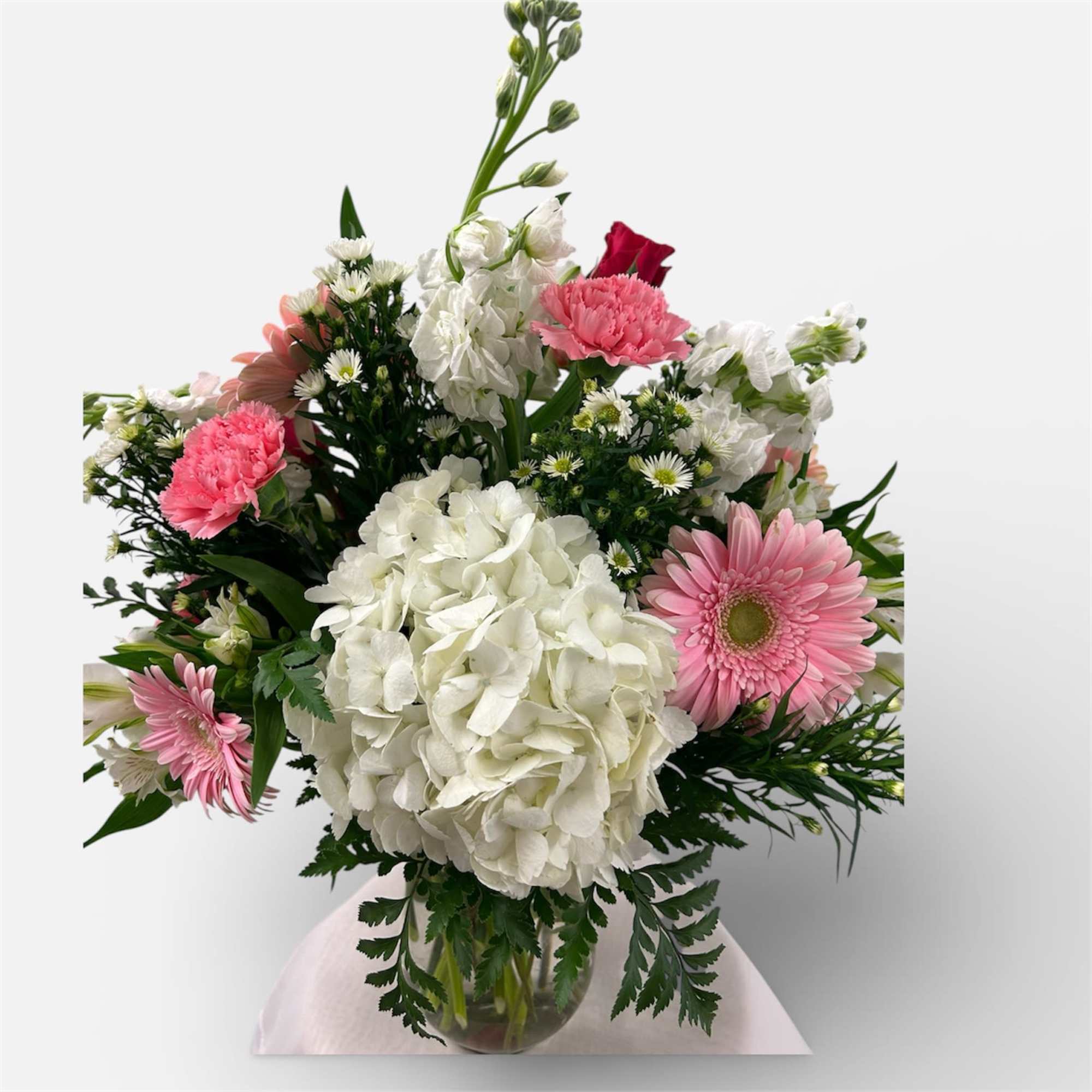 Soft pink gerbera daisies and fluffy white hydrangeas set a gentle, romantic, photo 2 of 2