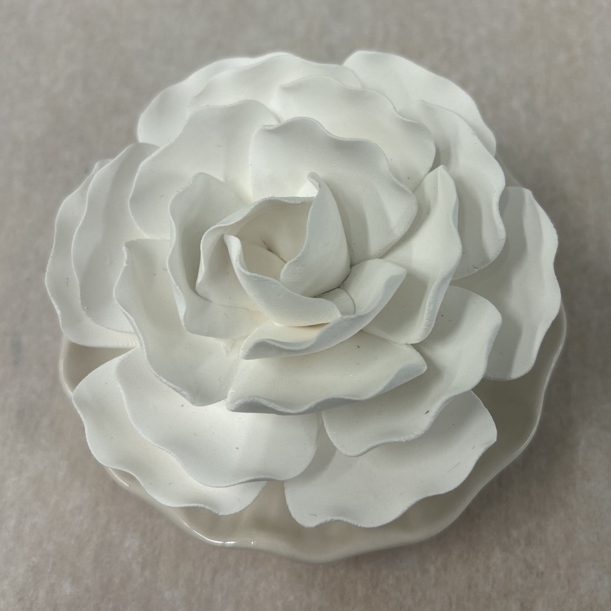 White artificial rose on a neutral background