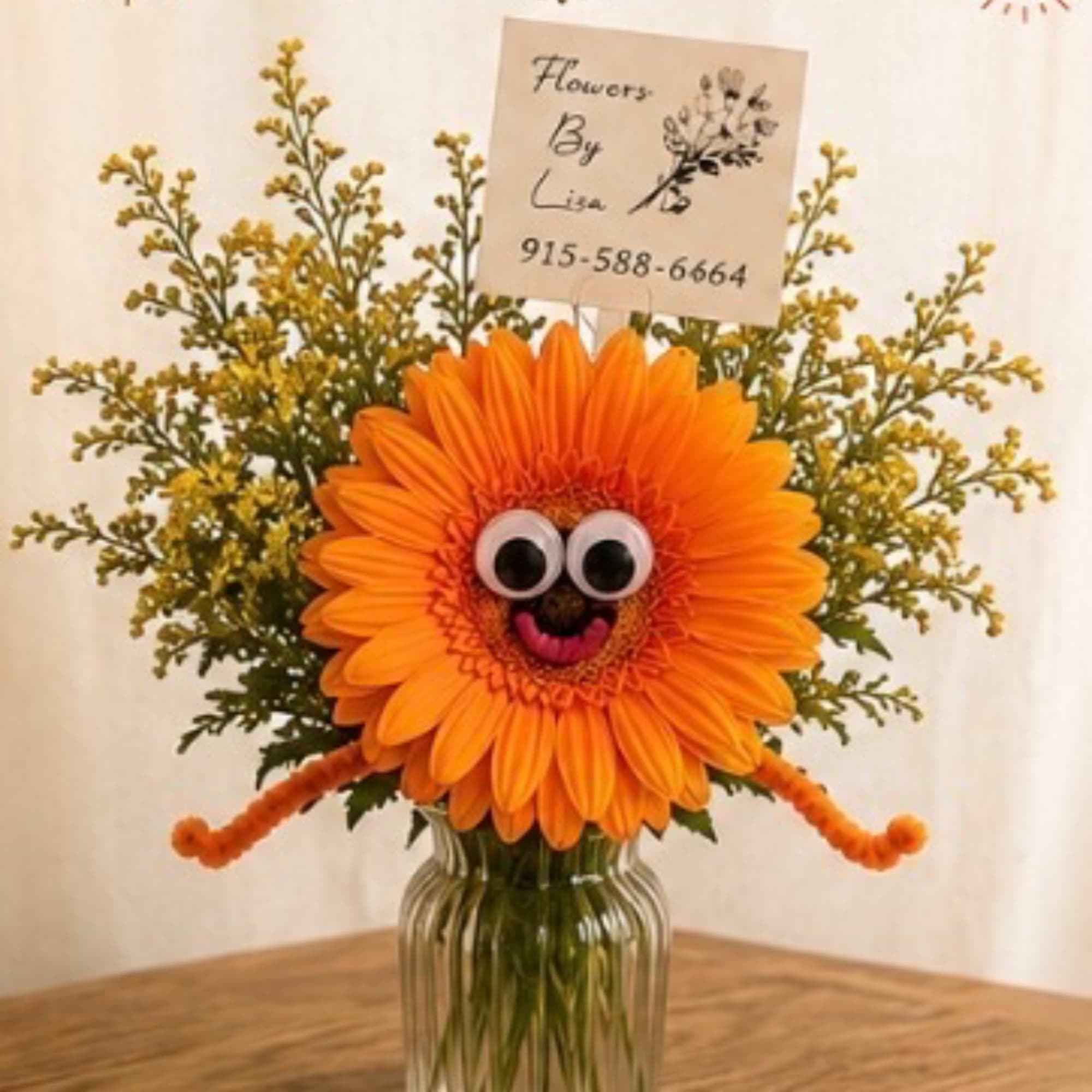 Orange gerbera daisy arrangement with a playful face in a glass vase