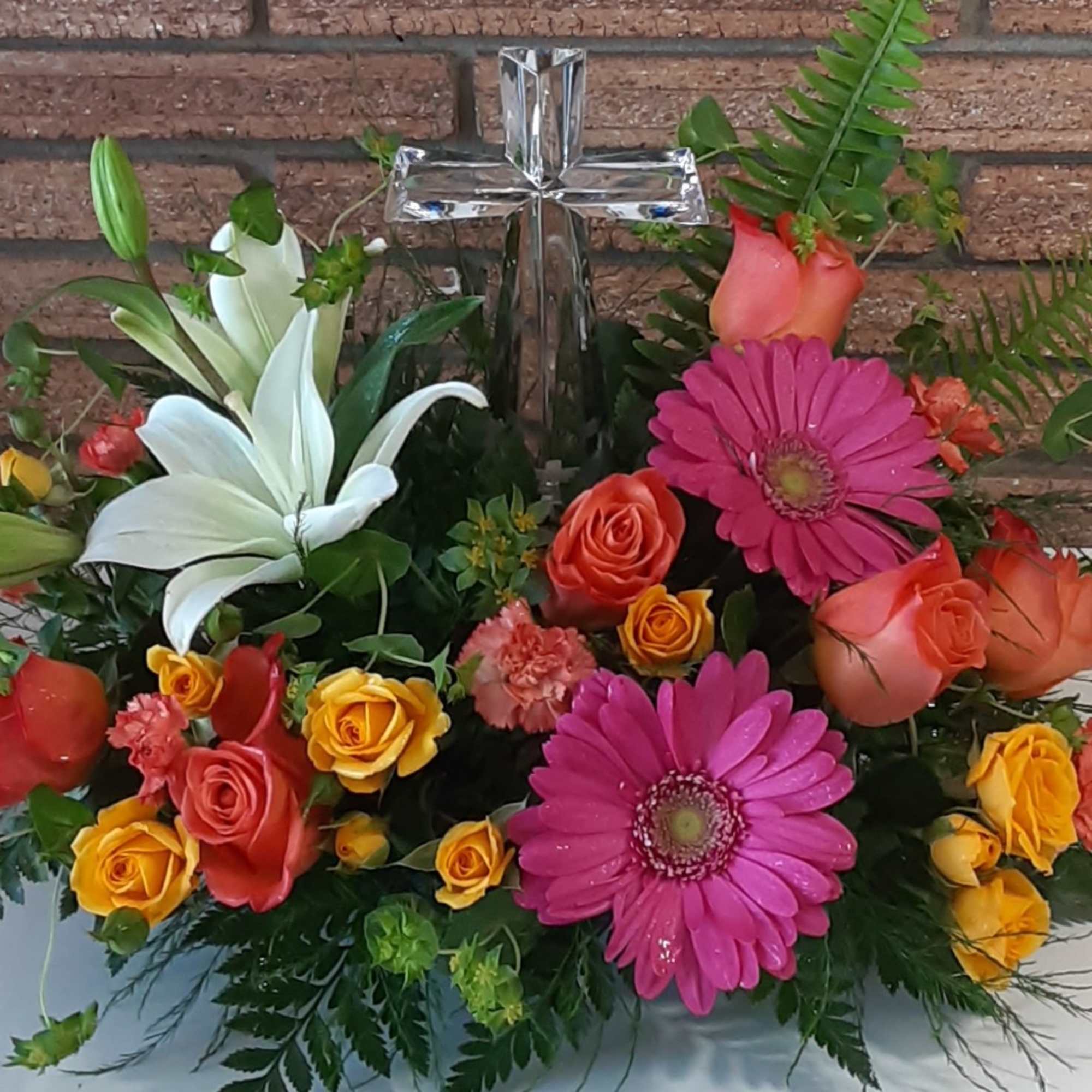 Colorful floral arrangement with lilies, roses, and gerbera daisies in a vase