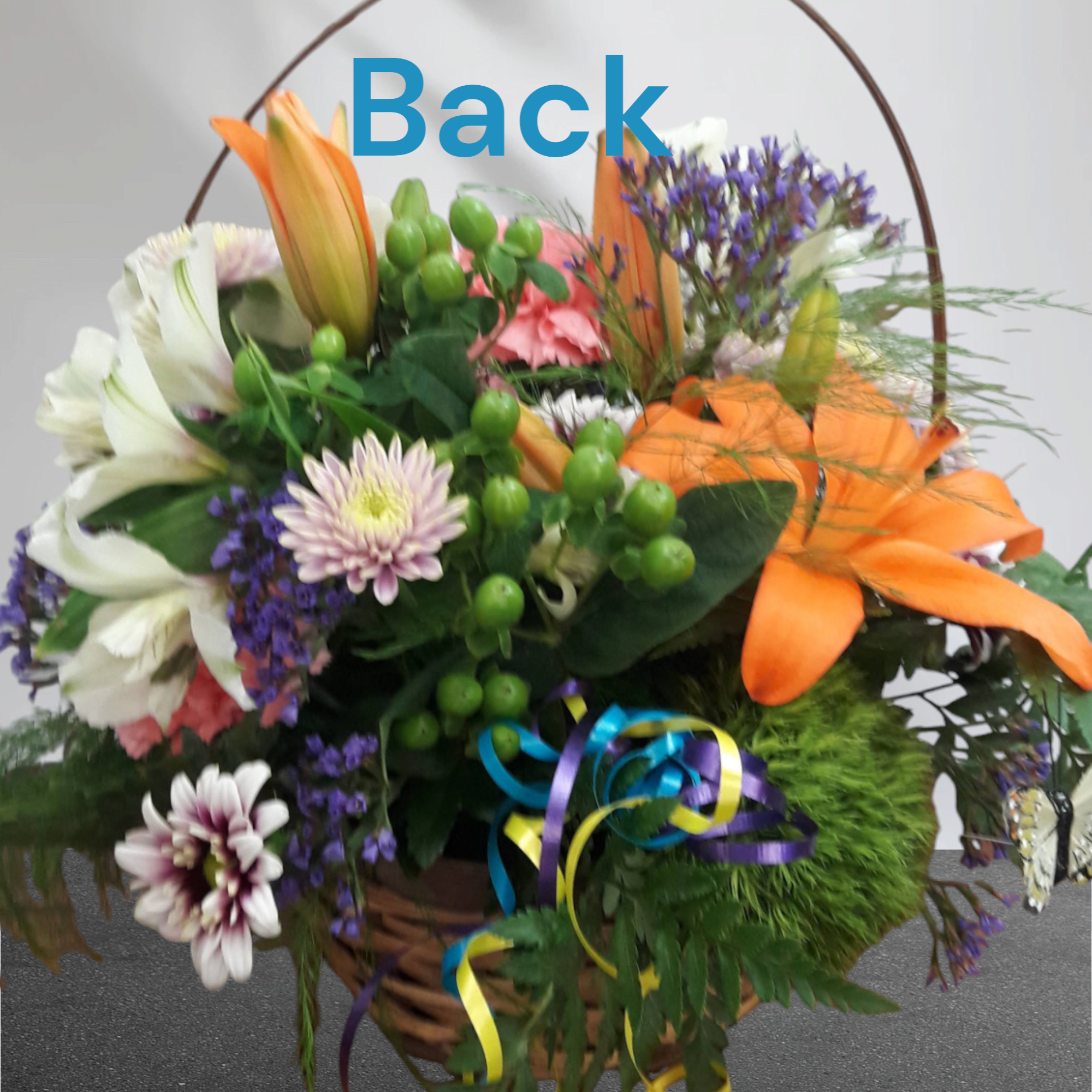 Mixed flower basket with lilies, chrysanthemums, and orange ribbon