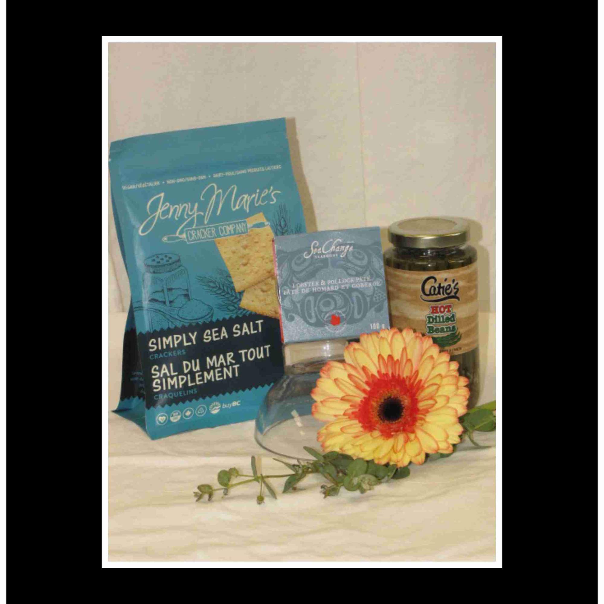 Gift basket with crackers, dip, beans, and a yellow gerbera daisy