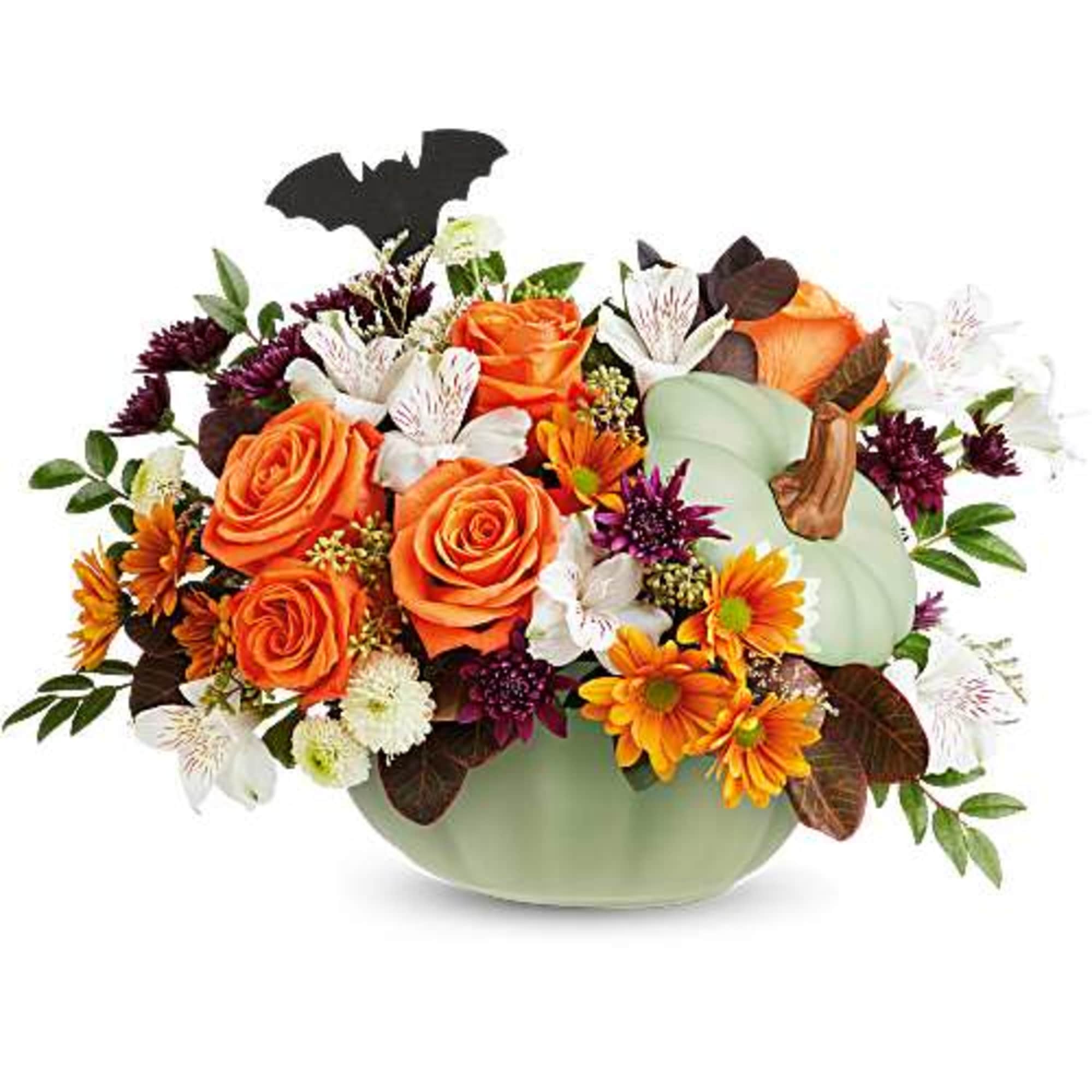 Orange roses and mixed flowers in a pale green pumpkin container with a bat pick