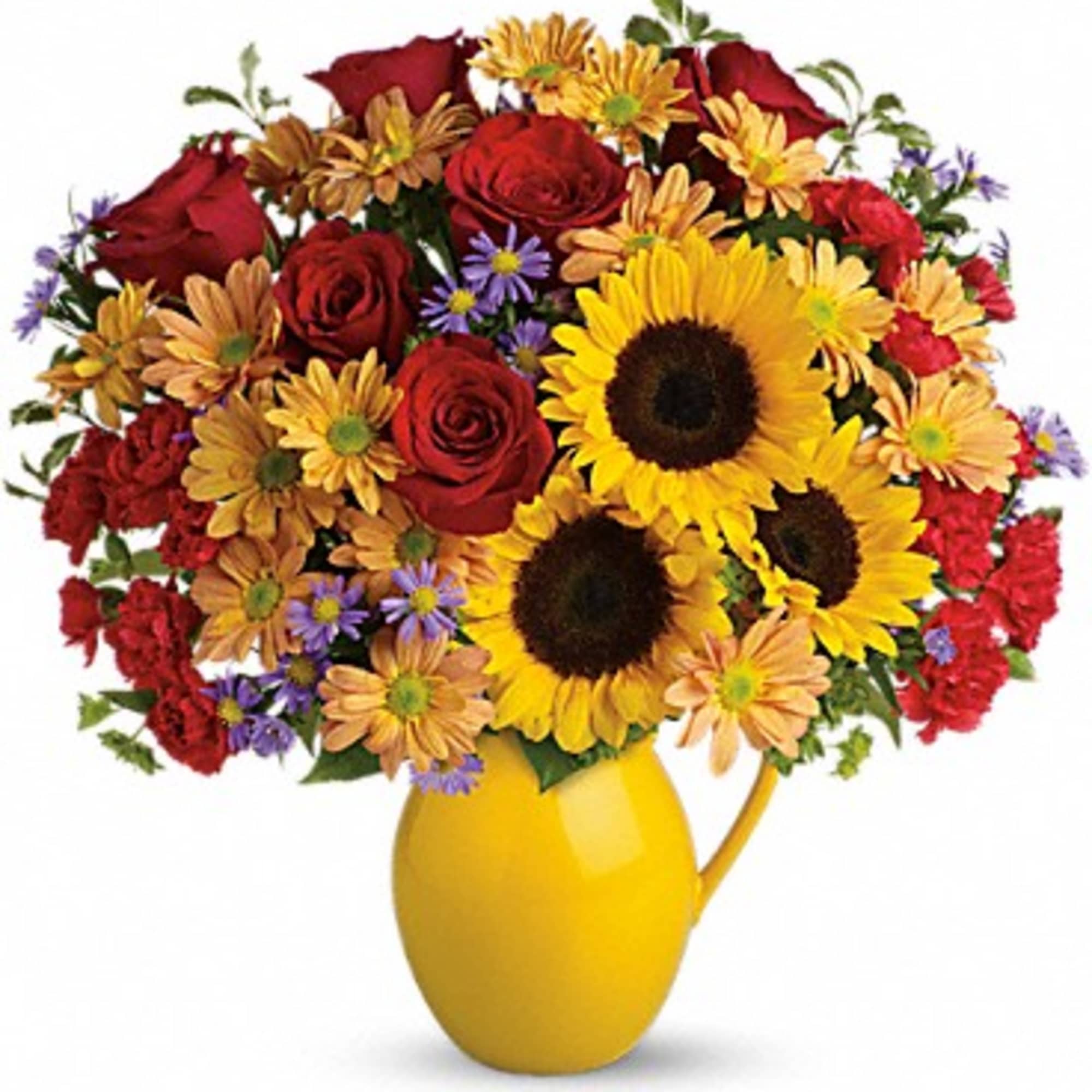Bouquet of sunflowers, red roses, and daisies in a yellow vase