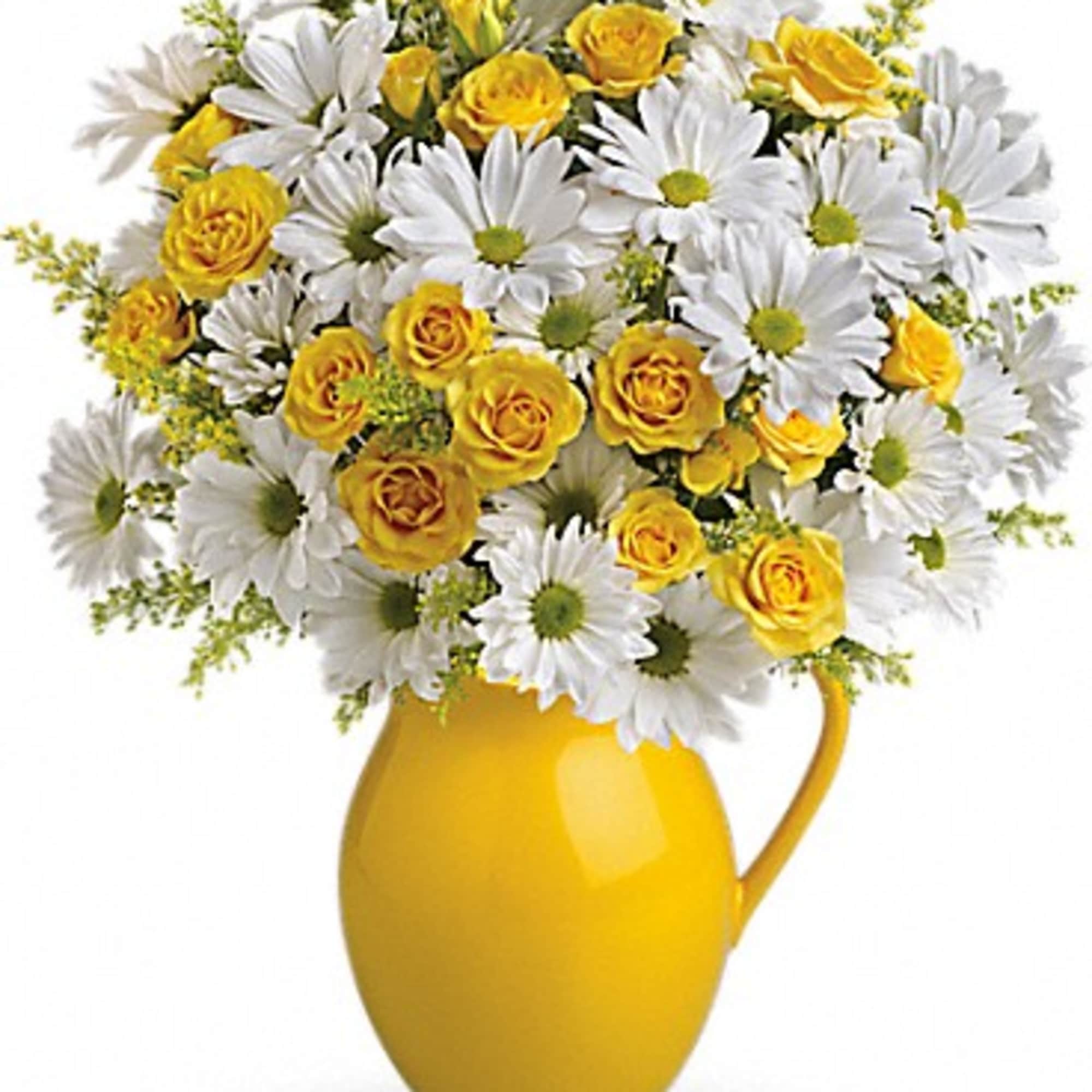 Yellow roses and white daisies in a yellow pitcher vase