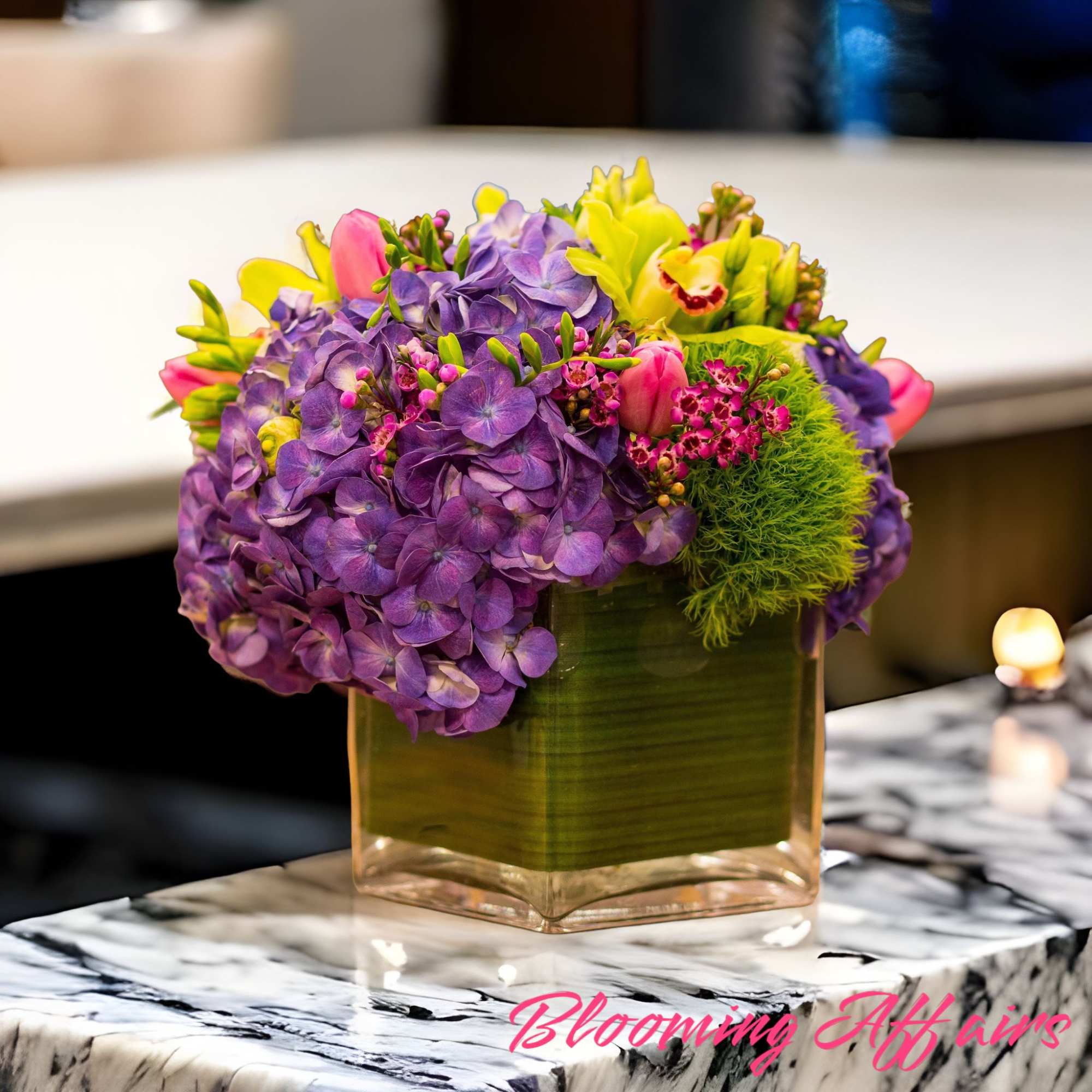 Purple hydrangeas and pink tulips in a square glass vase, photo 2 of 5