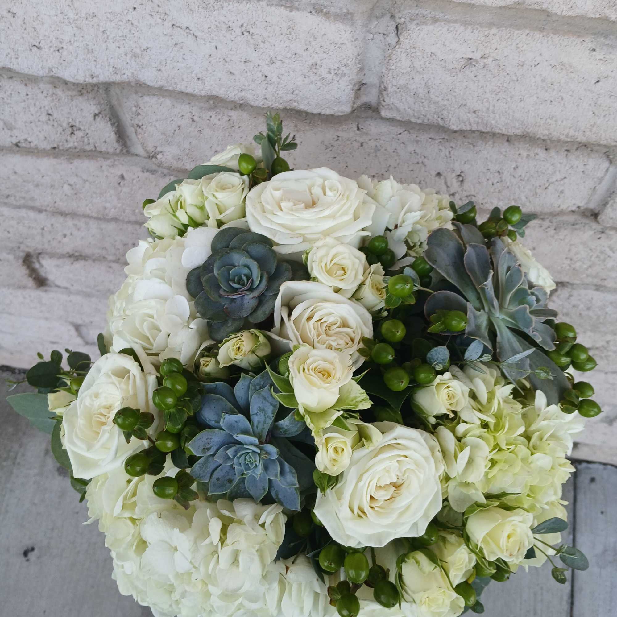 White rose and hydrangea bouquet with blue succulents
