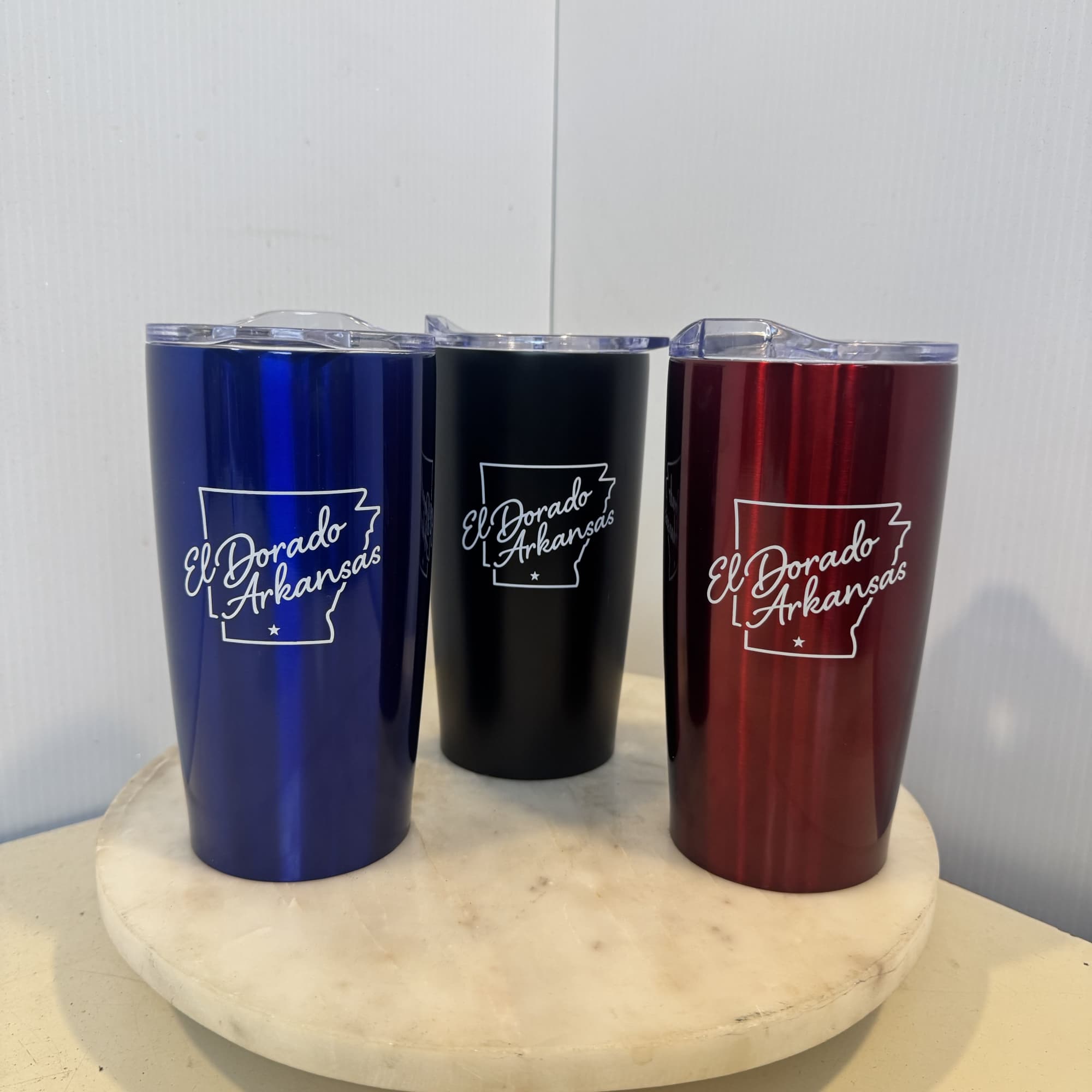 Three insulated tumblers with El Dorado Arkansas logos