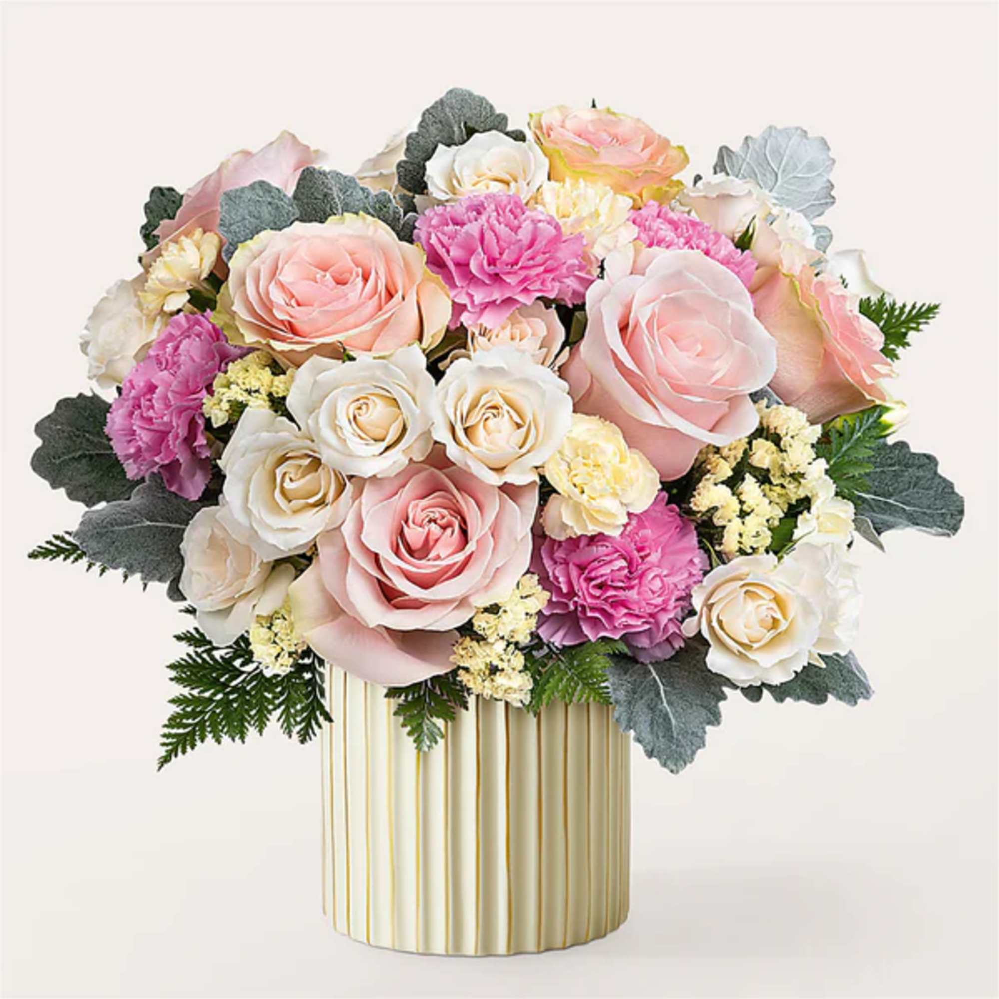 Pink and white rose bouquet in a striped gold vase
